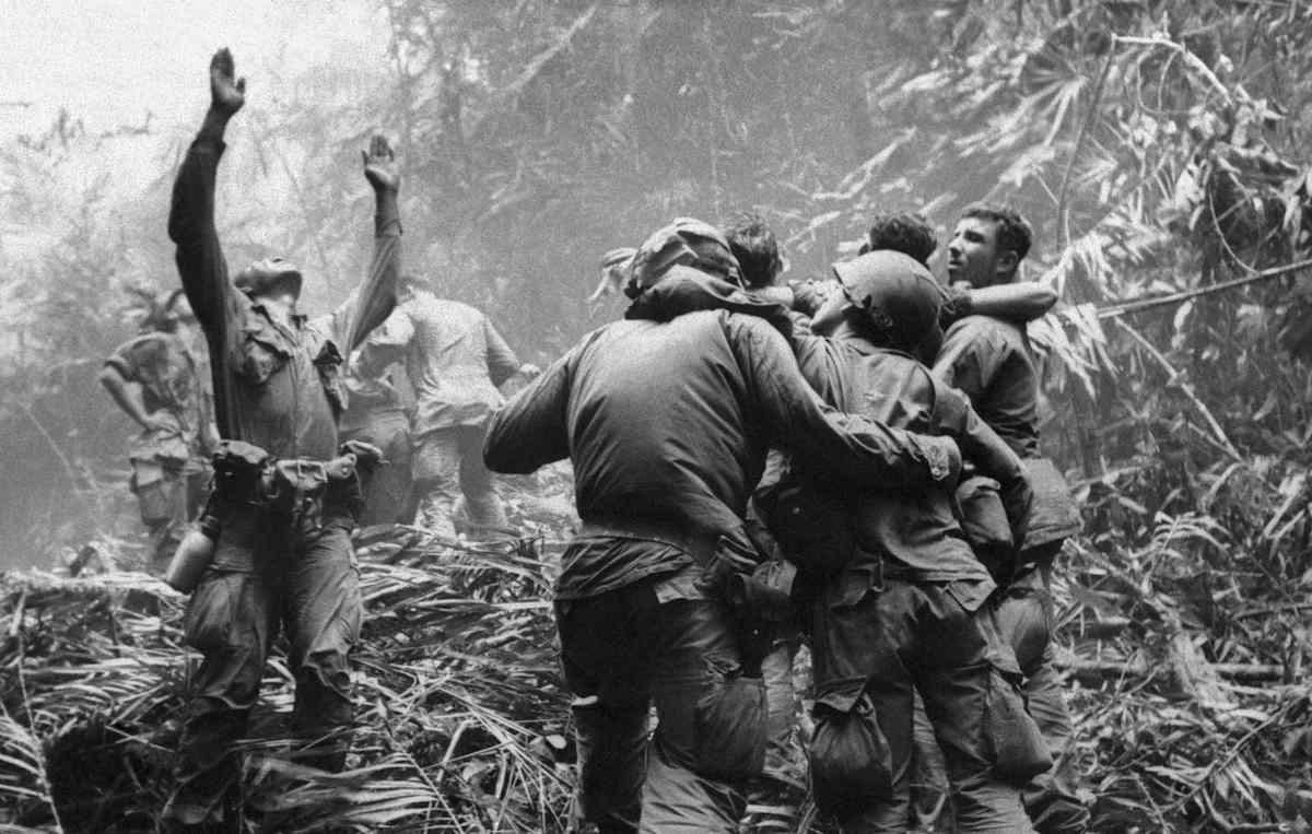 This April 1968 file photo shows the first sergeant of A Company, 101st Airborne Division, guiding a medevac helicopter through the jungle foliage to pick up casualties suffered during a five-day patrol near Hue.