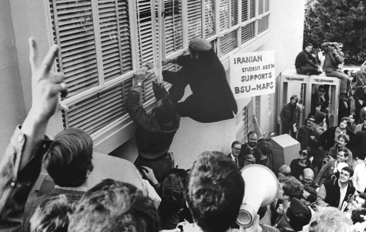 (Original Caption) 12/6/1967-San Francisco, CA- Demonstrators scale wall of Administration Building at San Francisco State College, to break into building, after authorities locked the doors and sent clerical employees home. Some 150 student activists, and another 2,000 onlookers took part in demonstration which protested alleged "political harrassment" and "racism."