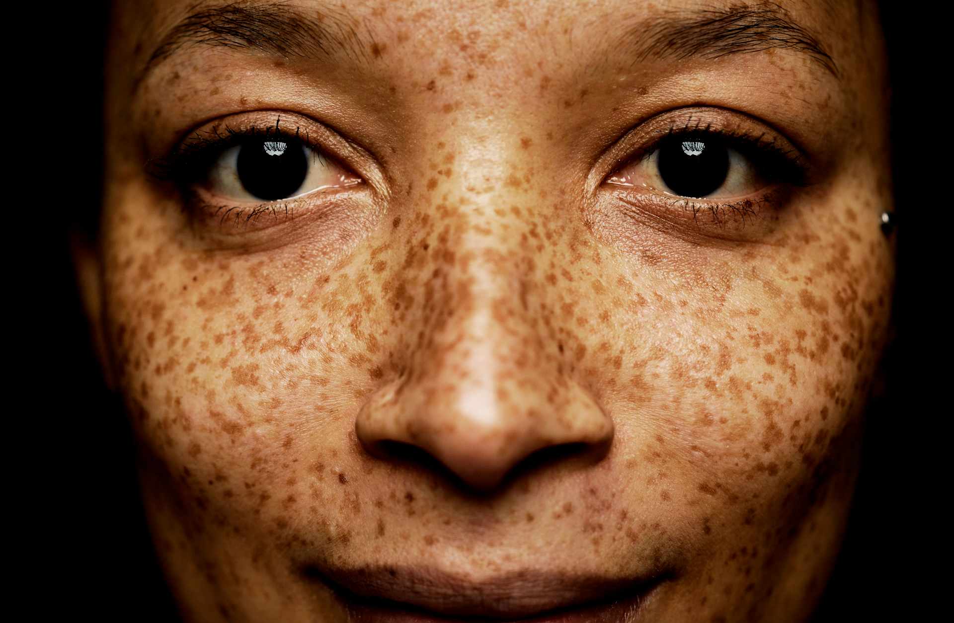 Mixed race woman with freckles close up of nose and freckles