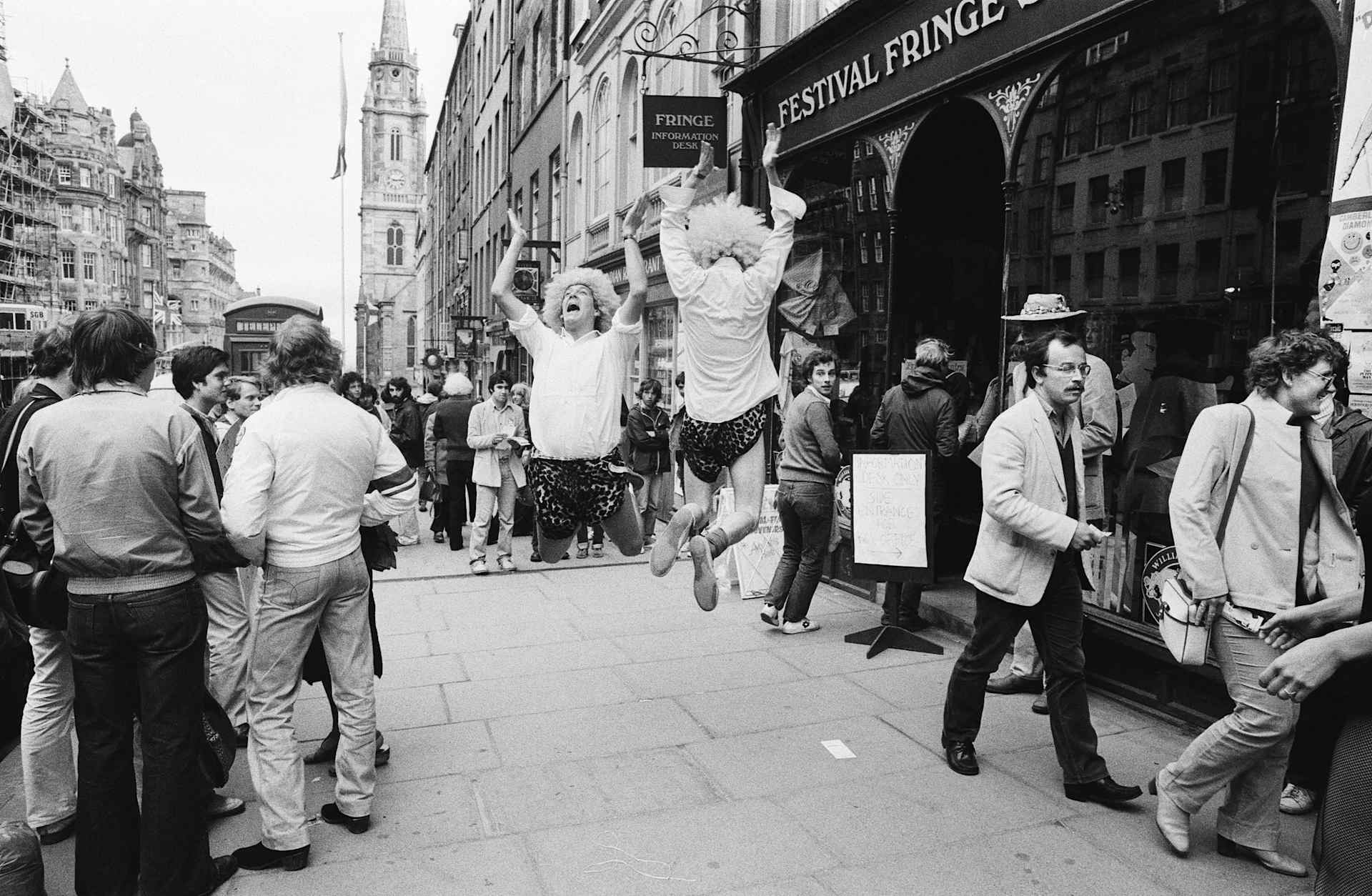 Acrobats in silly wigs entertaining the crowds on the streets of Edinburgh during the Edinburgh Festival Fringe, the world's largest performing arts festival. August 1980
