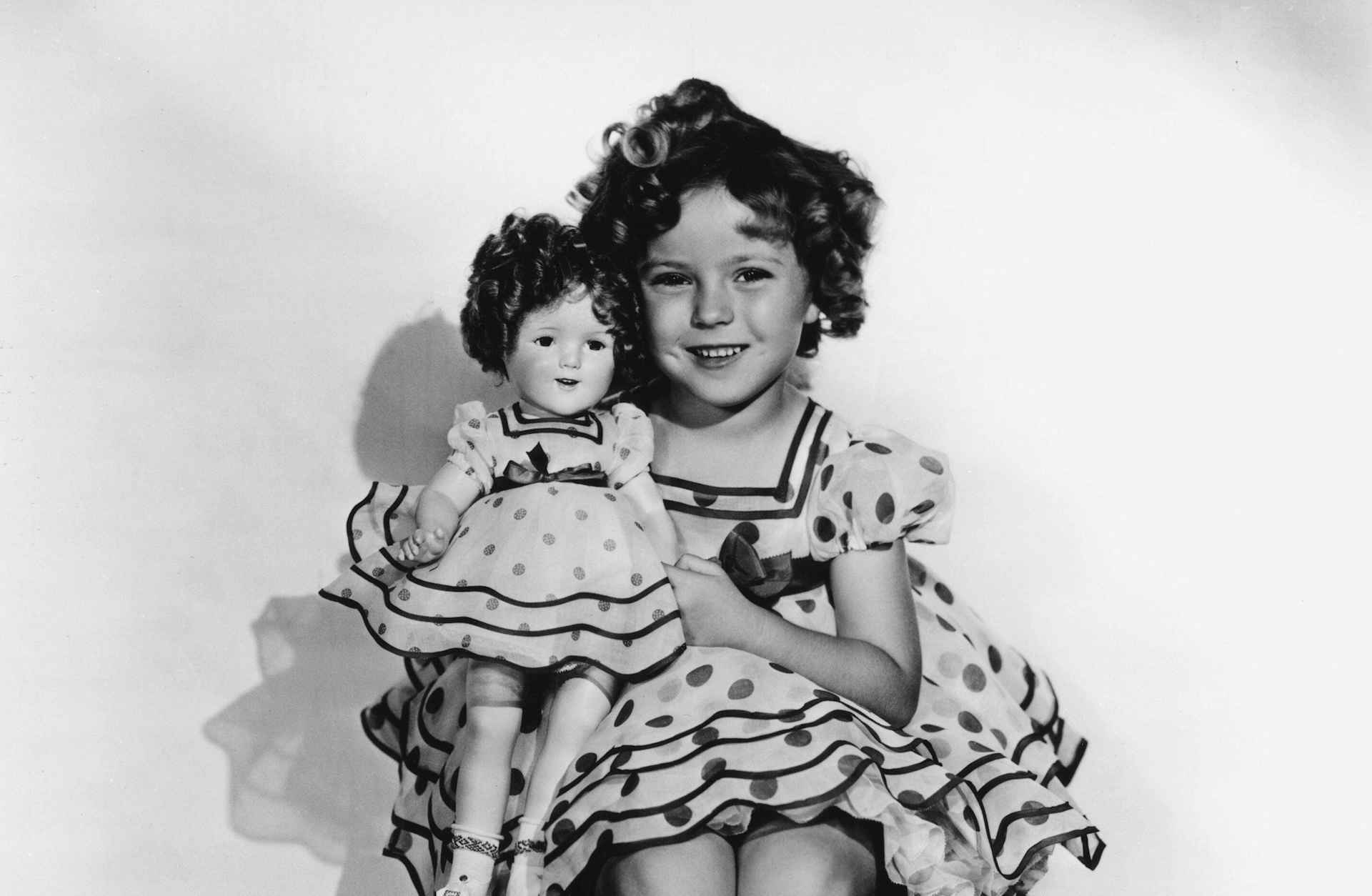 Fox movie publicity still of child actress Shirley Temple with her doll look-a-like, c. 1936