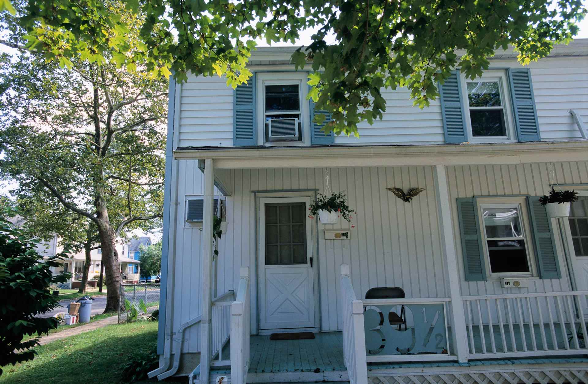 Childhood Home of Bruce Springsteen: modest two-story home with white siding and blue shutters.