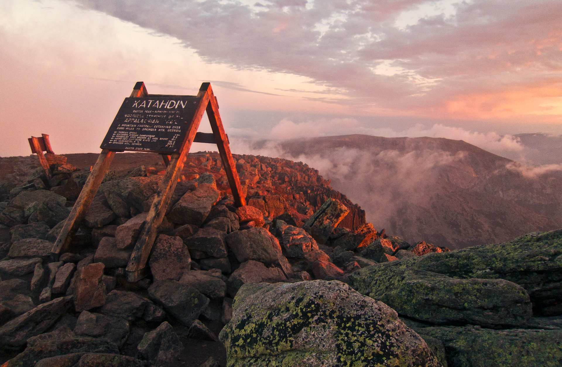 The summit sign on Maines Mount Katahdin seen at sunrise.
