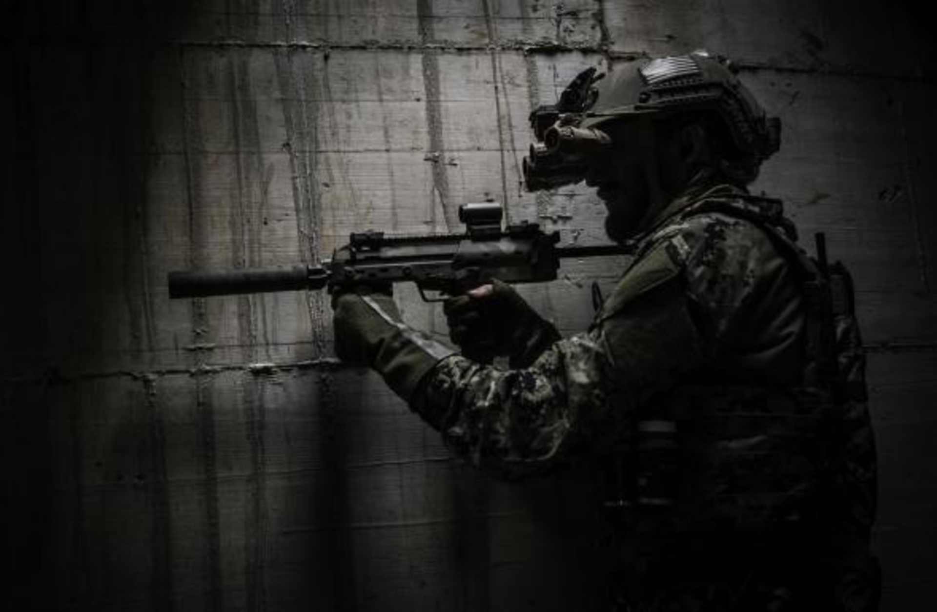 A combat ready special operation forces soldier with a MP7 silenced submachine gun and a night vision google. (Credit: MILpictures/Getty Images)