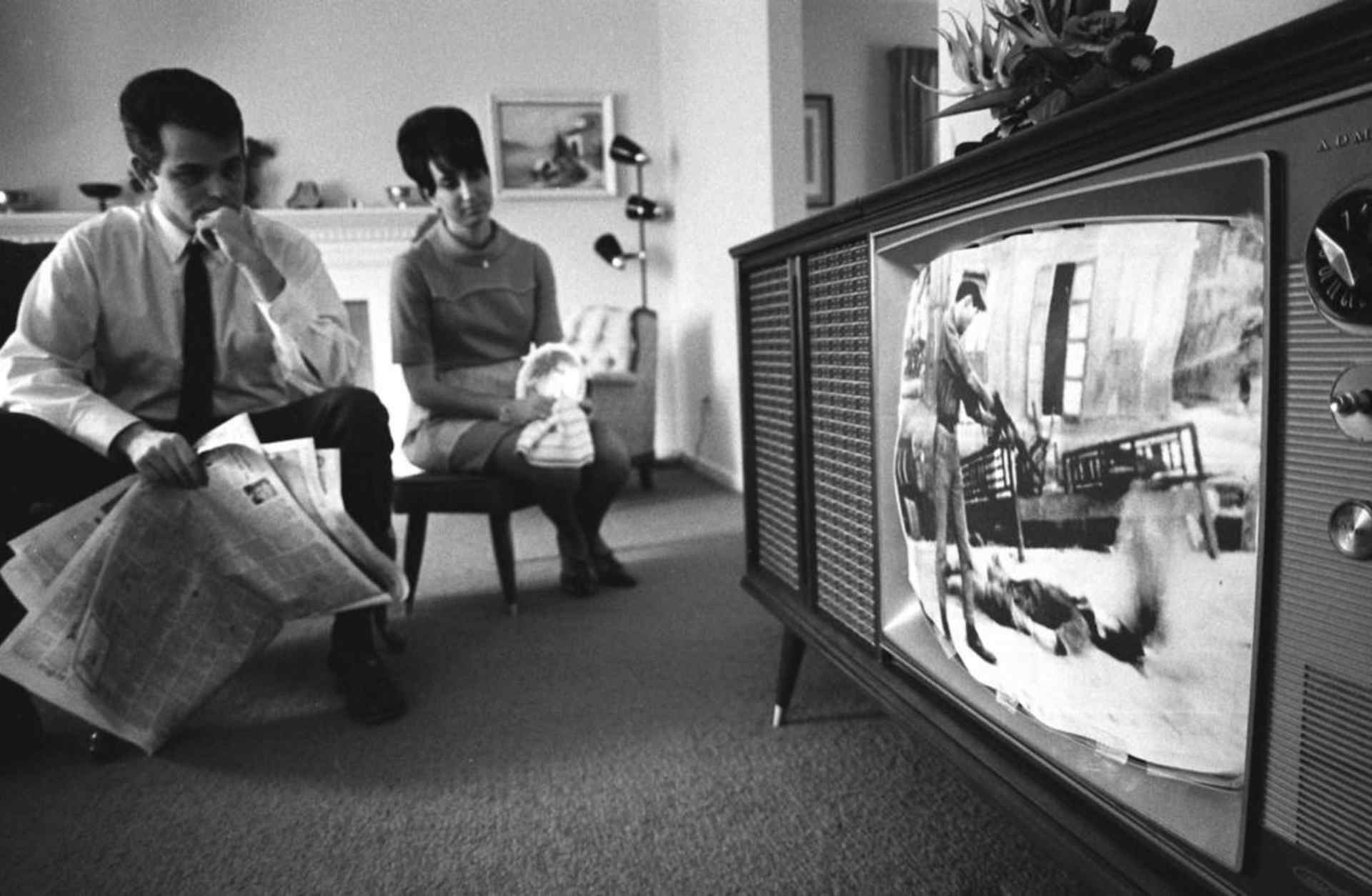 A couple watching news footage of the Vietnam war in their home. (Credit: Photo 12/UIG/Getty Images)