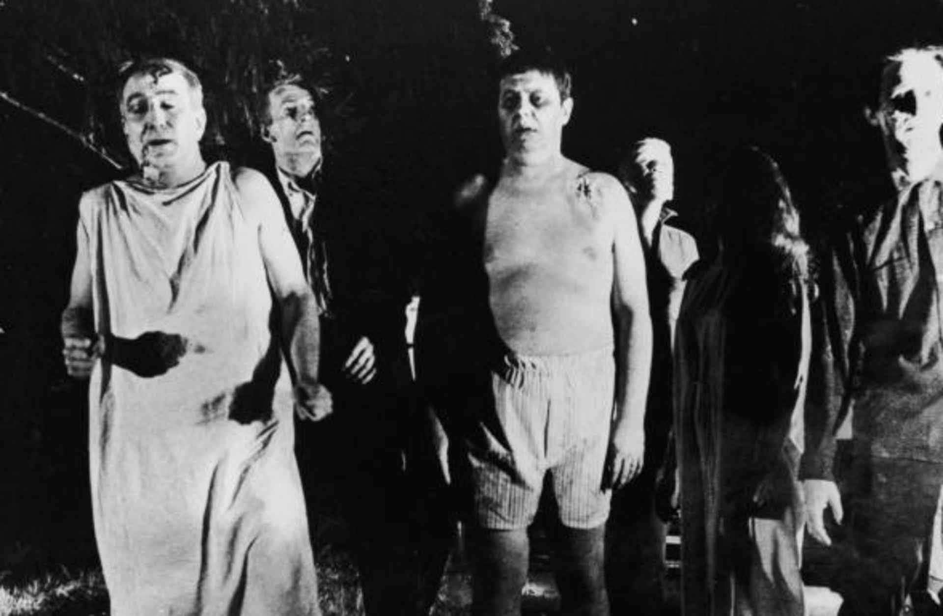 A line of undead 'zombies' walk through a field in the night in a still from the film, 'Night Of The Living Dead,' directed by George Romero, 1968. (Credit: Pictorial Parade/Getty Images)