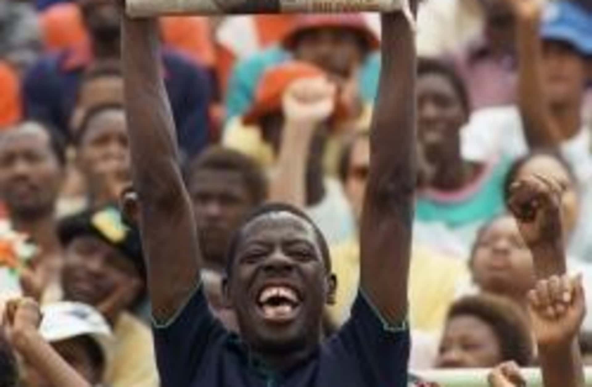 A Sowetan holds up a newspaper announcing Mandela's release. (Credit: Trevor Samson/AFP/Getty Images)