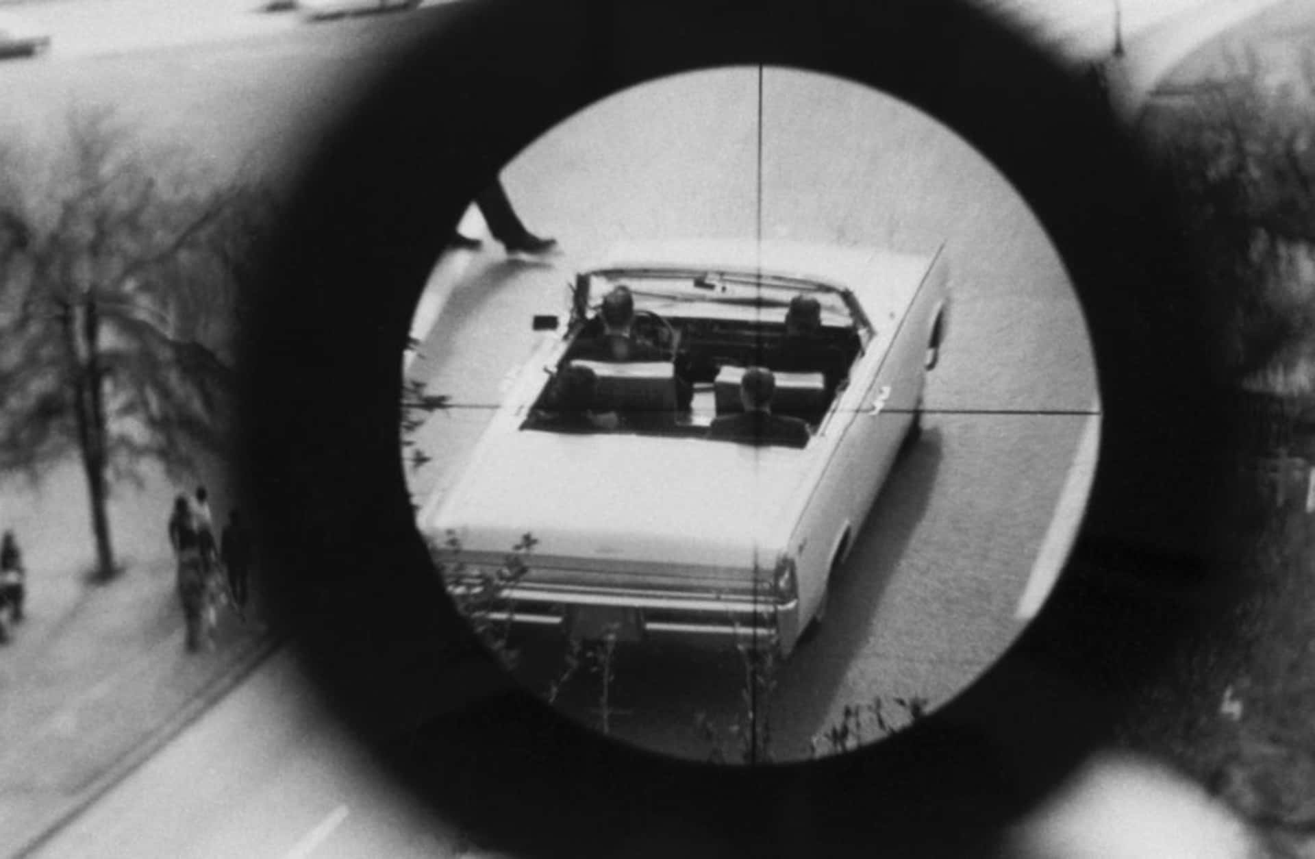 A view through a gun sight from the Texas School Book Depository is part of a reenactment of the Kennedy assassination. This evidence was submitted to the Warren Commission. (Credit: Corbis via Getty Images)