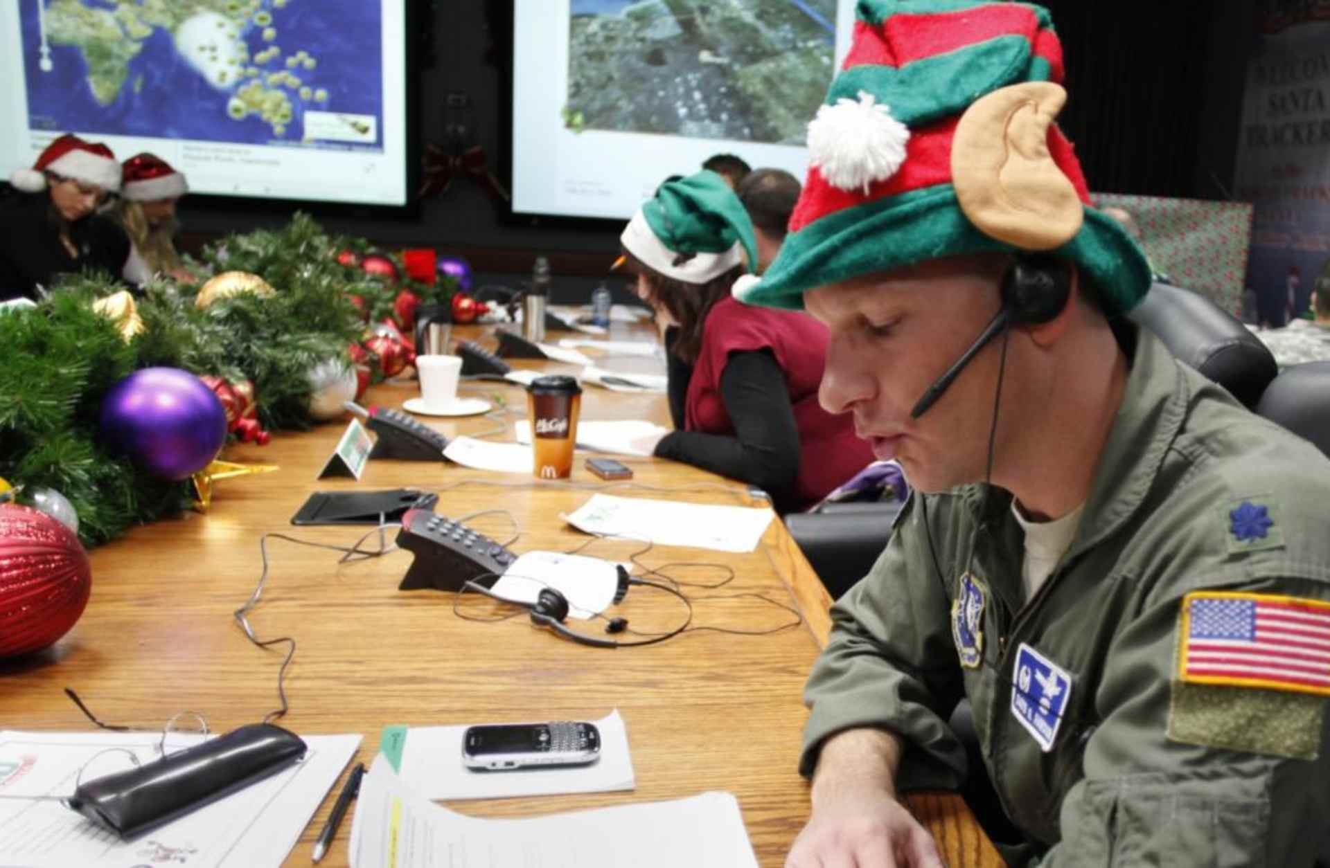 Air Force Lt. Col. David Hanson of Chicago taking a phone call from a child in Florida at the Santa Tracking Operations Center at Peterson Air Force Base near Colorado Springs. (Credit: Ed Andrieski/AP Photo)