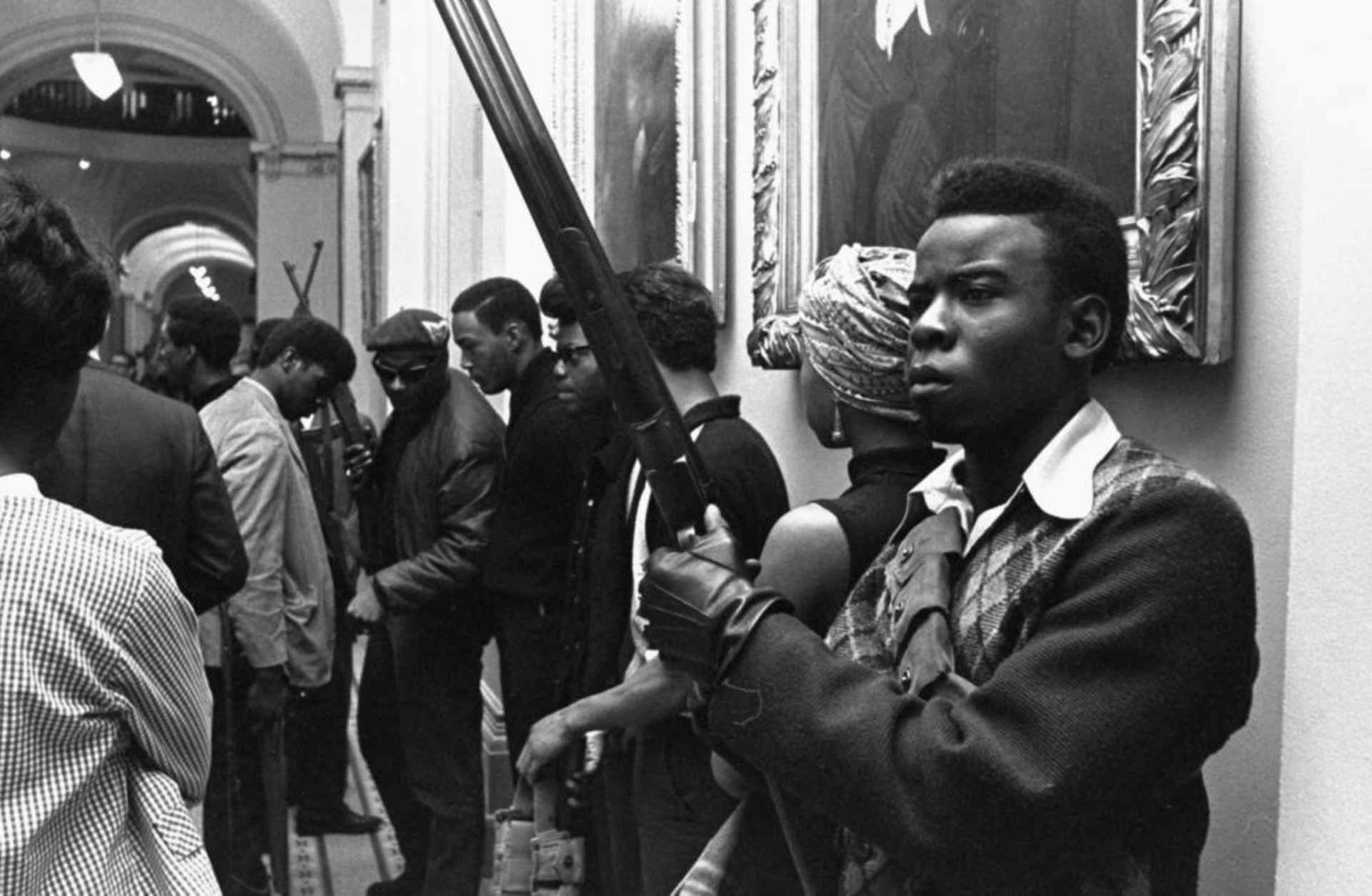 Armed members of the Black Panther Party standing in the corridor of the Capitol in Sacramento protesting a bill that restricted the carrying of arms in public, 1967. (Credit: Walt Zeboski/AP Photo)