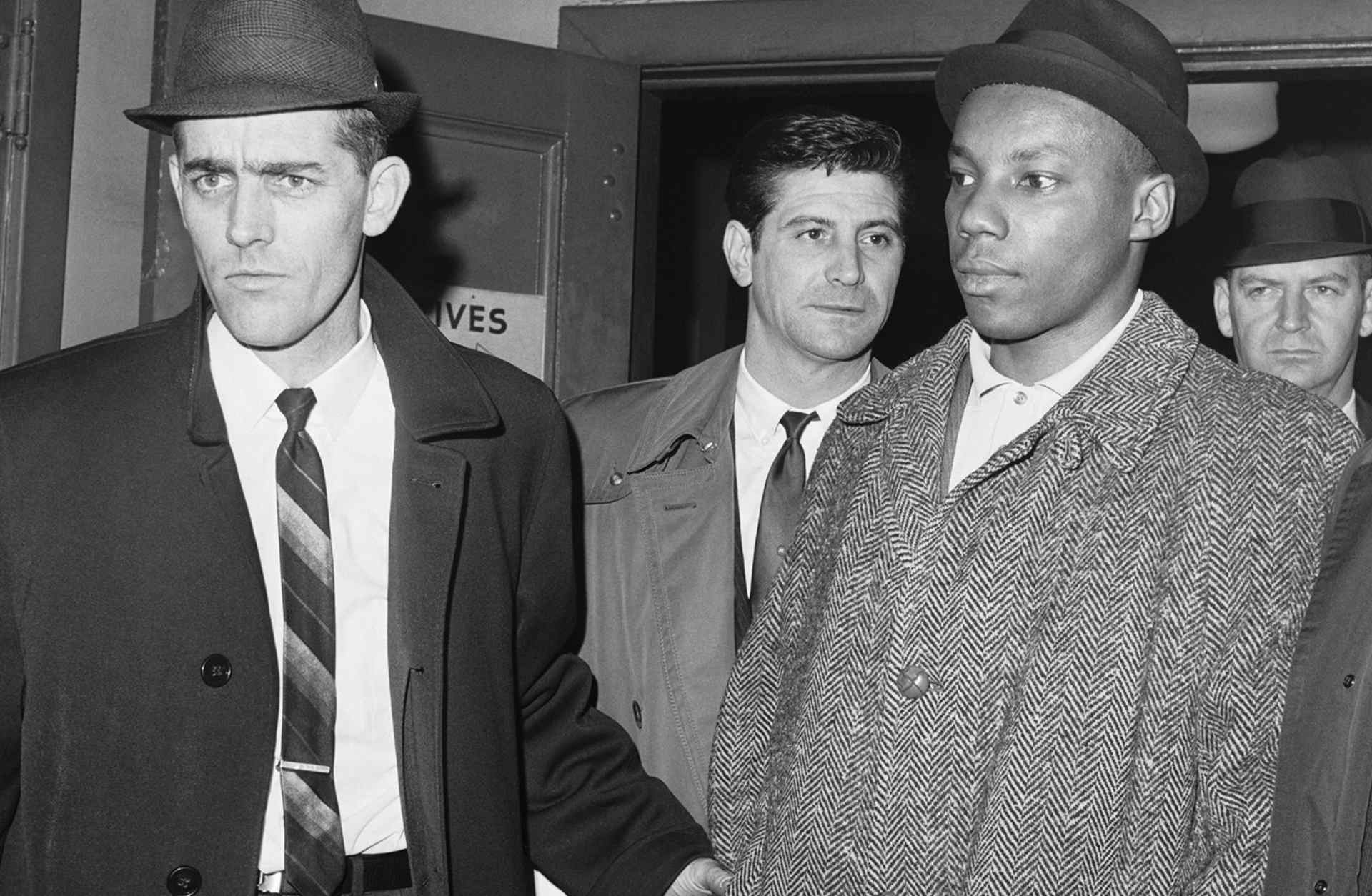 Police escort Muhammad Abdul Aziz, formerly known as Norman 3X Butler, into a jail in New York on February 26, 1965.