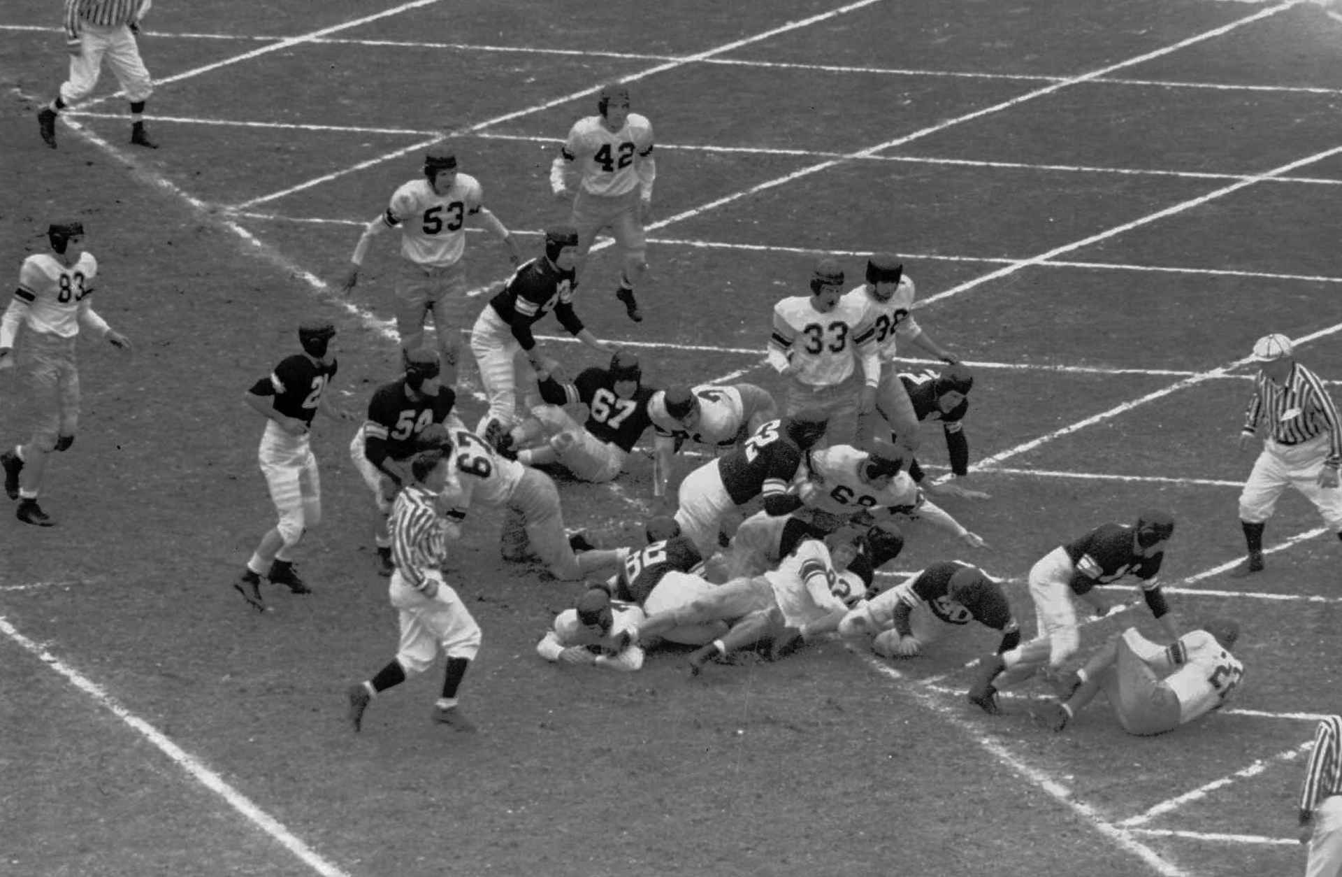 An overhead view of disputed Rose Bowl play in which fullback Art Murakowski (30) of Northwestern was credited with scoring a touchdown against California before he fumbled the ball during the Rose Bowl in 1949 in Pasadena, Calif. Field judge Jay Berwanger, lower right, was in perfect position to see whether Murakowski had crossed the goal line before losing posesssion, and he called it a touchdown. Ball, hidden by Northwestern's Tom Worthington, right of Murakowski, was recovered by fullback Will Lotter (33) of California. (AP photo/stf)