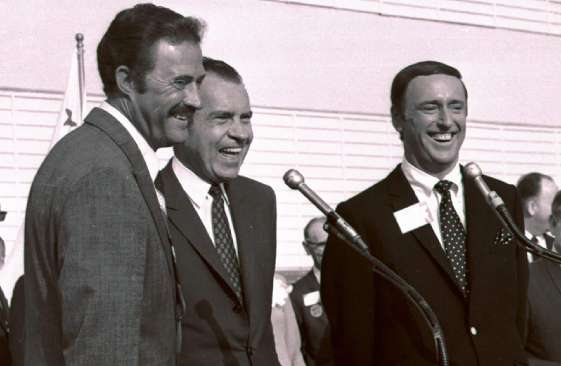 Comedians Dan Rowan, left, and Dick Martin, hosts of 'Rowan & Martin's Laugh-In' with then-Republican presidential candidate Richard Nixon during a rally in Burbank, California, October 1968. (Credit: AP Photo)