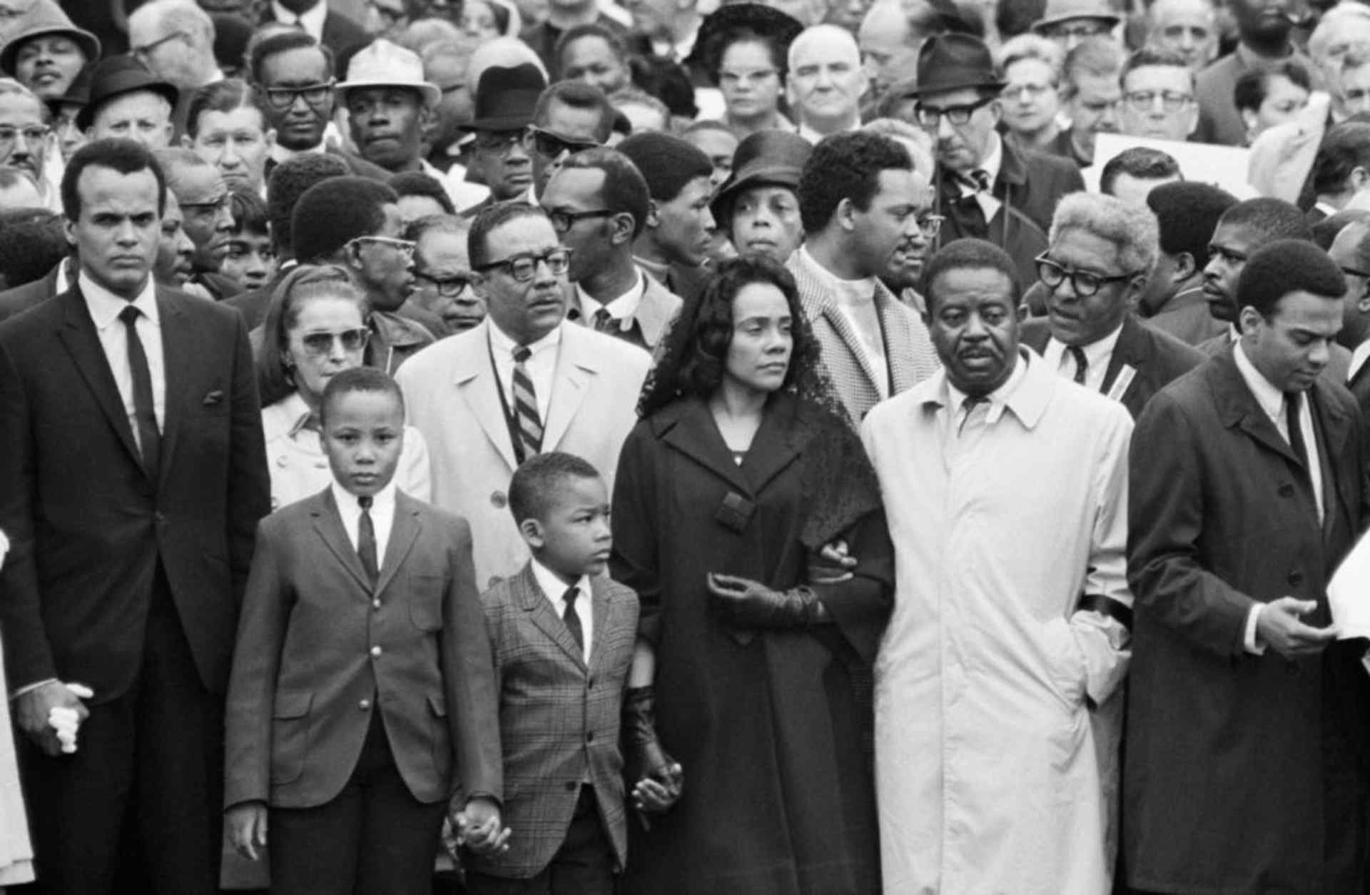 Coretta Scott King, on the arm of Dr. Ralph Abernathy, her husband's successor as head of the Southern Christian Leadership Conference, leads a march of some 10,000 persons in Memphis on April 8th, as a memorial to Dr. Martin Luther King. Jesse Jackson is pictured behind Mrs. King. (Credit: Bettmann Archive/Getty Images)
