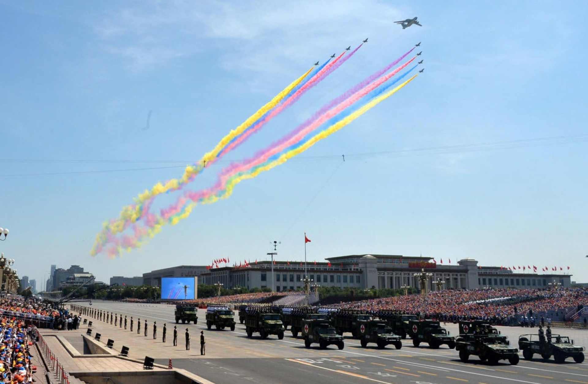Chinese military helicopters and planes fly past the Tiananmen Gate, leaving colored contrails, as part of a celebration of the 70th anniversary of the end of World War II.
