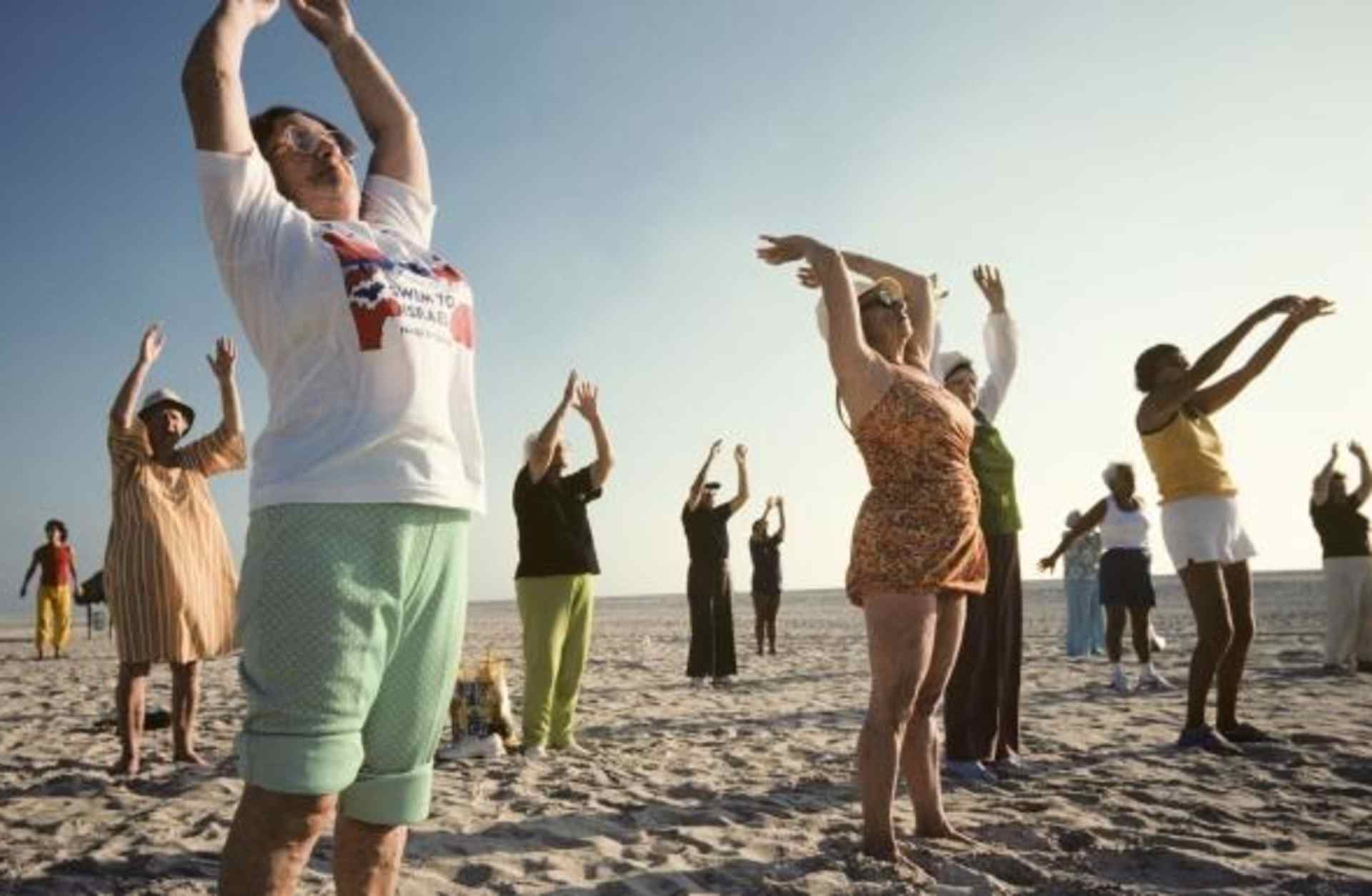Elderly people doing outdoor early morning exercises in a class on Miami Beach
