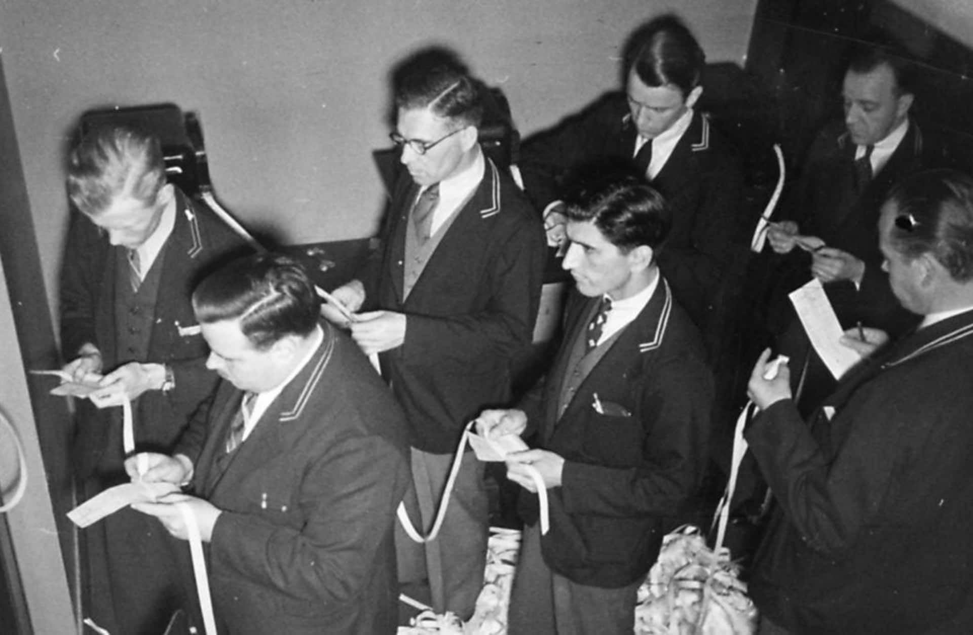 Ffloor traders checking the stock prices on ticker tape at the New York Stock Exchange, taken in New York City, 1938. (Credit: University of New Hampshire/Gado/Getty Images)