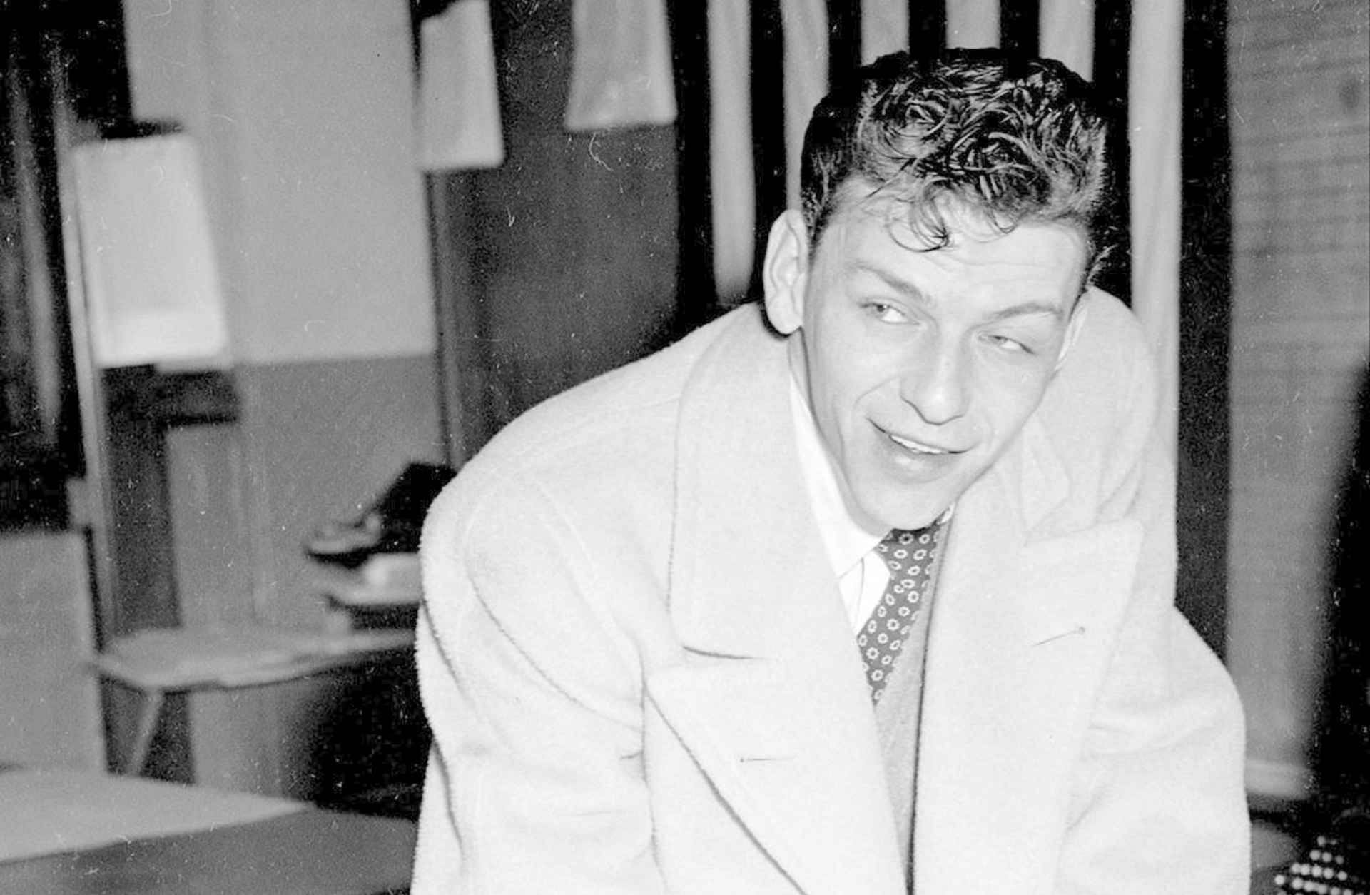 Frank Sinatra signing papers before leaving his draft board in Newark, New Jersey. Speaking of his rejection, the singer said, "I am very unhappy about it. If I had been accepted, I would have preferred the Army or Marines." (Credit: NY Daily News Archive/Getty Images)