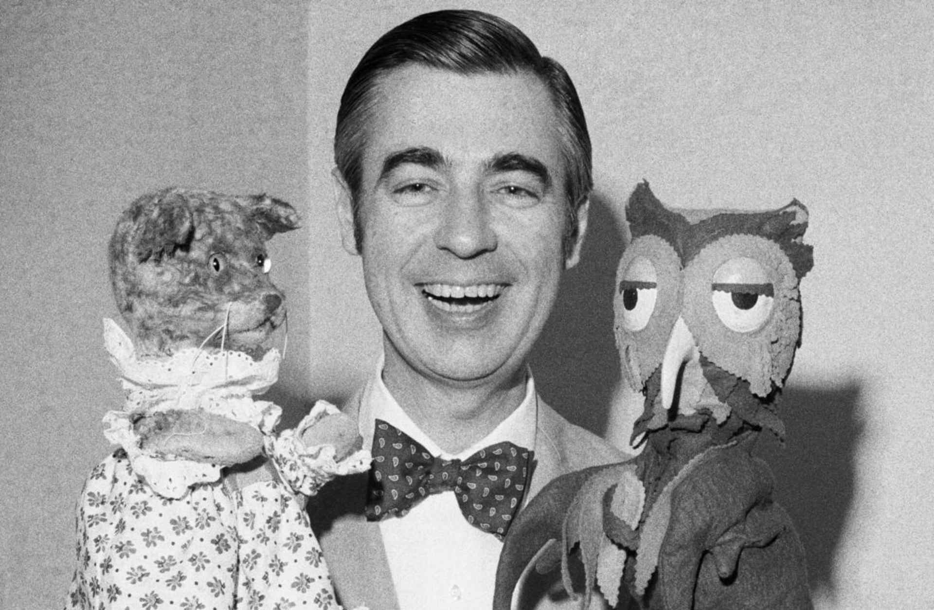 Fred Rogers of Mister Rogers' Neighborhood holds Henrietta Pussycat (left) and "X" the Owl during an interview. Rogers is an ordained Presbyterian minister and his ministry works to reach out to children and their families through mass media.
