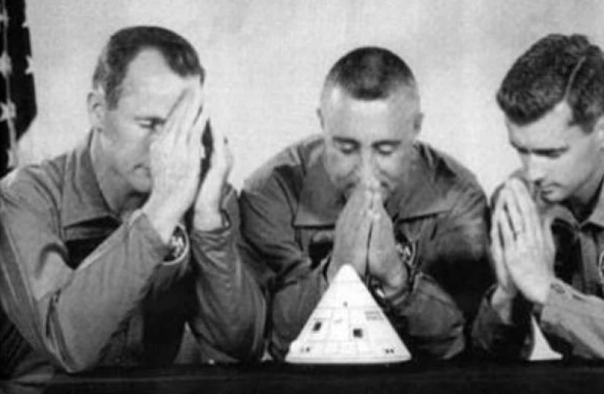Gag photo of Apollo 1 crew in prayer.