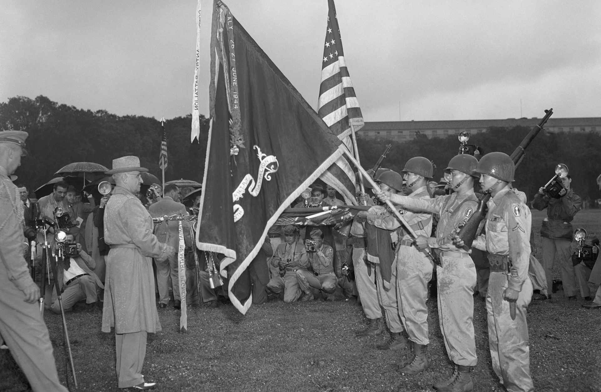 July 15, 1946: After President Harry S. Truman inspects the famed 442nd Regimental Combat Team, he pins the Presidential Distinguished Unit Citation banner to the colors of the unit. Composed of Americans of Japanese ancestry, the 442nd distinguished itself in combat in Europe.