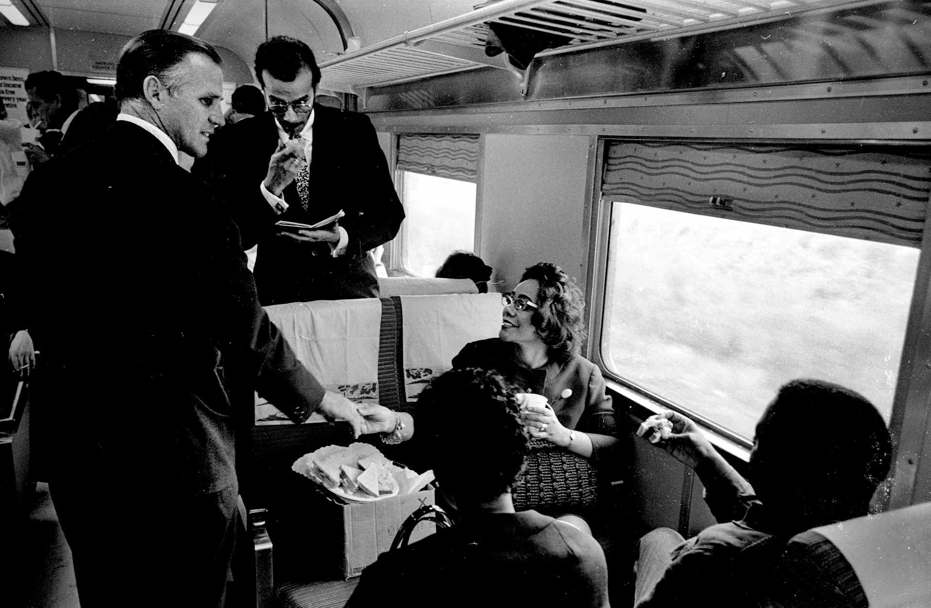 June 8, 1968: Passengers mingled and shared stories on the 8-hour train ride which brought the body of assassinated senator Robert F. Kennedy from New York to Washington, D.C. Here, an unidentified man shakes the hand of Coretta Scott King, widow of Dr. Martin Luther King Jr., who had been killed just two months earlier.