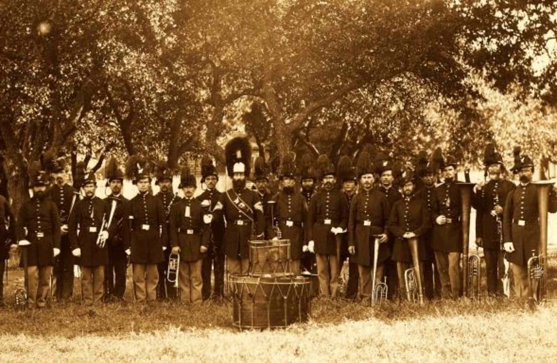 Group portrait of the band, 24 uniformed men, many of whom are holding musical instruments, Fort Monroe, VA, 1864. They are wearing hats with plumes. (Credit: Buyenlarge/Getty Images)