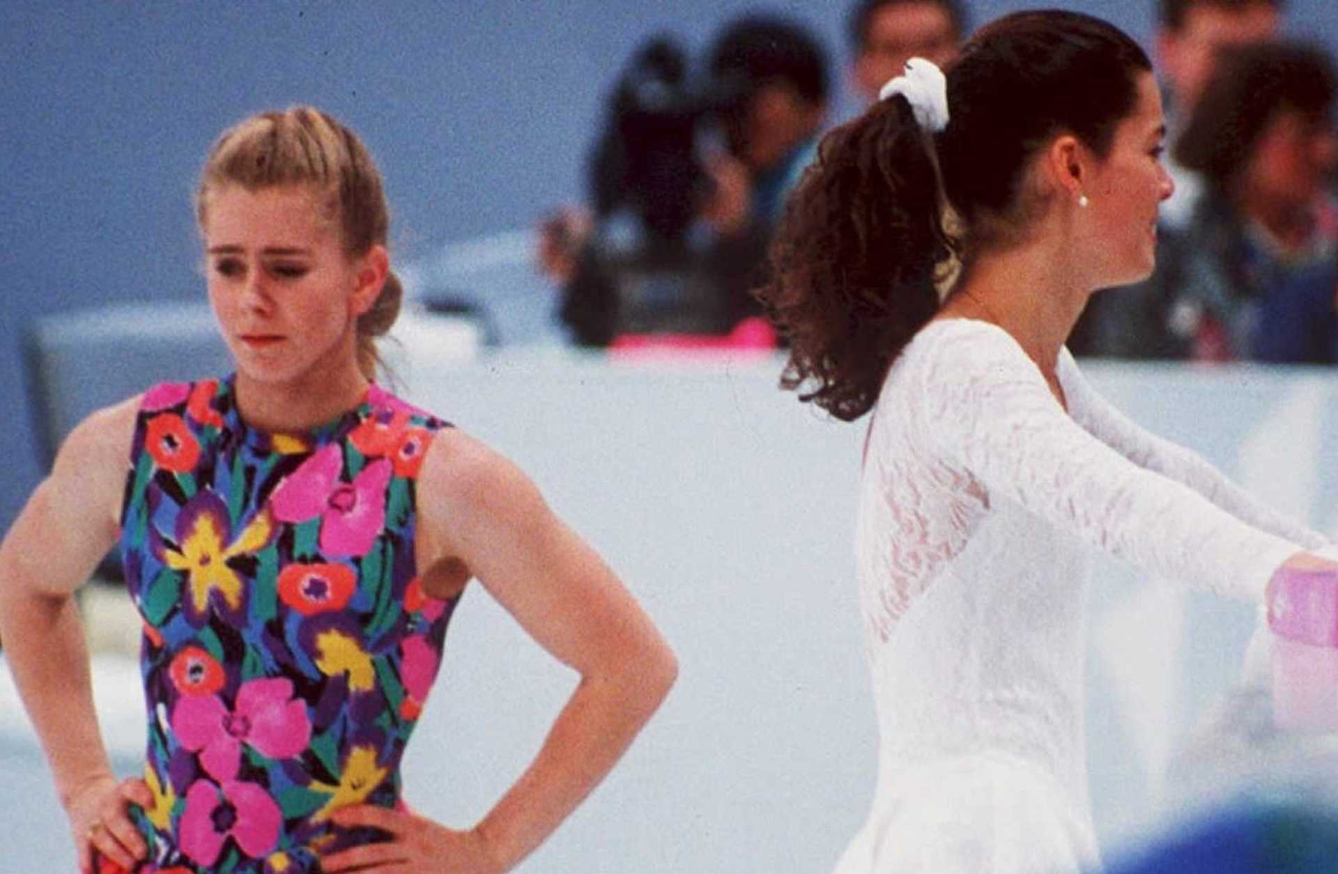 US figure skaters Tonya Harding (L) and Nancy Kerrigan avoid each other during a training session 17 February in Hamar, Norway, during the Winter Olympics. Kerrigan was hit on the knee in January 1994 during the US Olympic Trials and it was later learned that Harding's ex-husband and bodyguard masterminded the attack in hopes of improving Harding's chances at the US Trials and the Olympics. (COLOR KEY: Harding has yellow) (Photo credit should read VINCENT AMALVY/AFP via Getty Images)