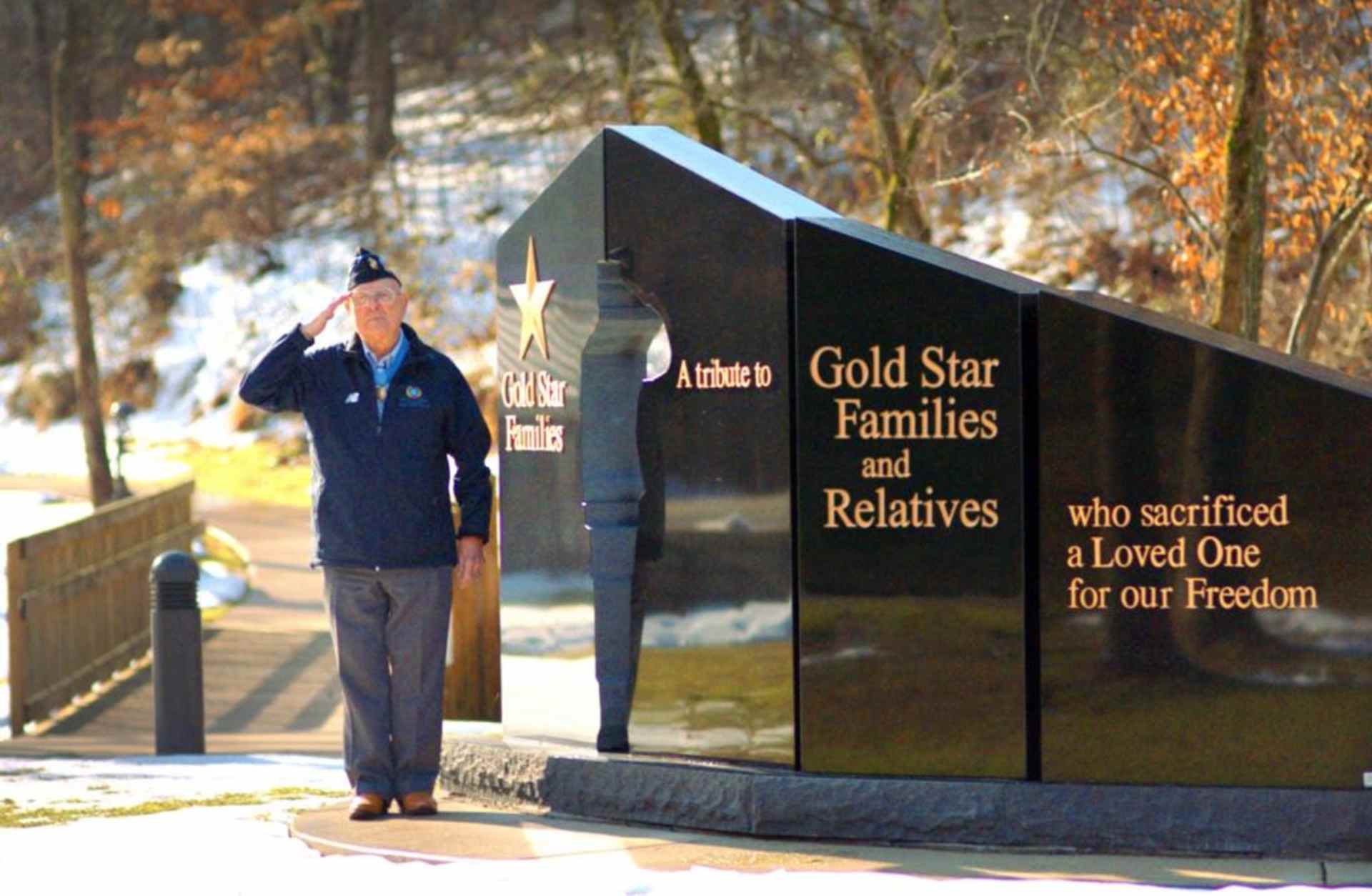 Hershel "Woody" Williams saluting next to the Gold Star Families Memorial Monument. This monument is to honor Gold Star Families, preserve the memory of the fallen, and stand as a stark reminder that Freedom is not free. (Courtesy of the Hershel Woody Williams Medal of Honor Foundation)