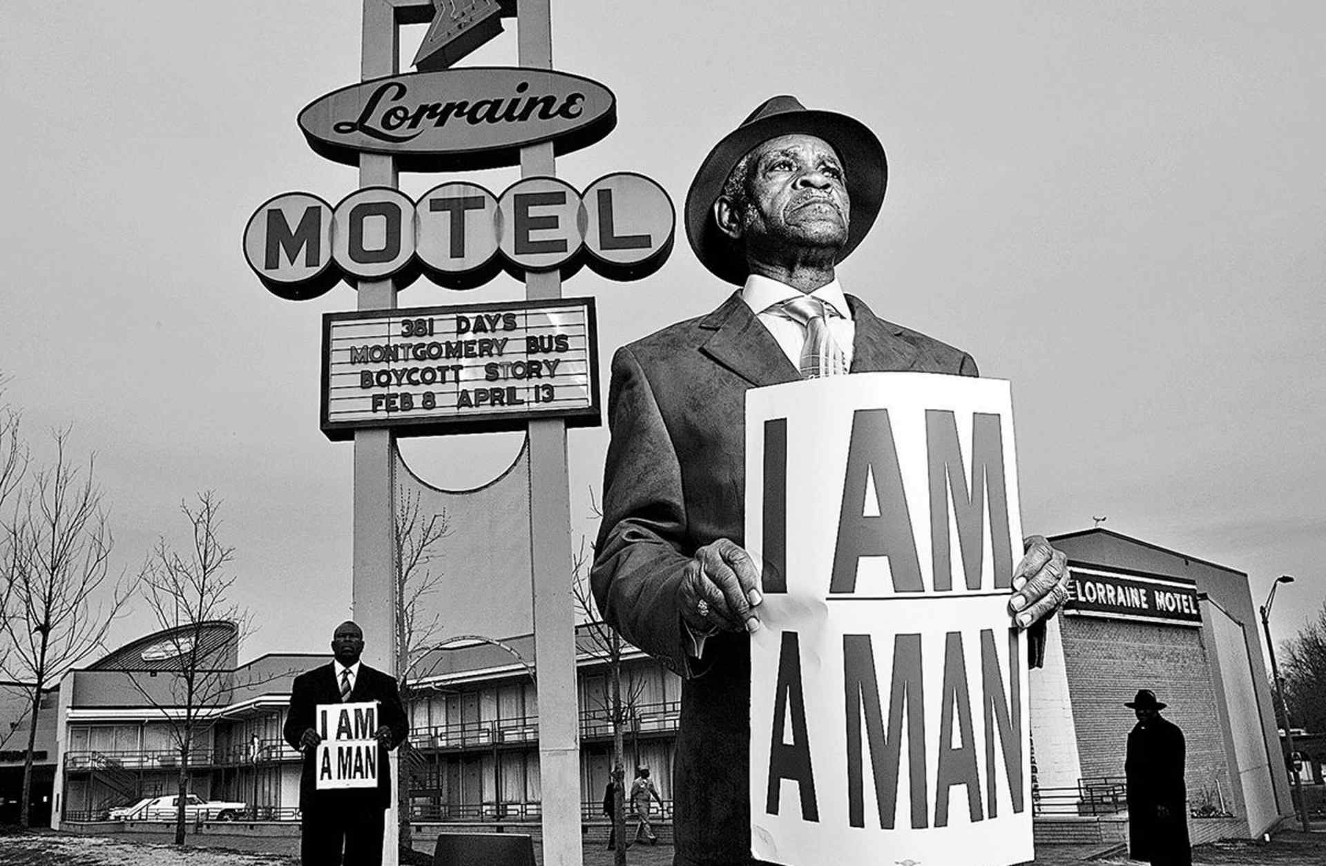 Memphis sanitation workers Elmore Nickelberry, 76, center, and his son, Terrence, left, holding replica signs used by the 1968 Memphis strikers, in front of the former Lorraine Motel where Martin Luther King, Jr. was assassinated, 2008. (Credit: Carl Juste/Miami Herald/MCT via Getty Images)