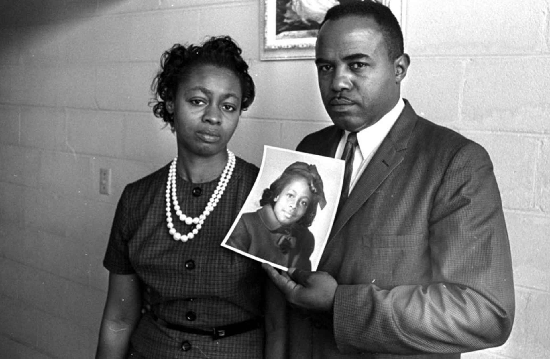 Mr. and Mrs. Chris McNair with a picture of their daughter, Denise, 11, who was one of the four girls who died in the 16th Street Church bombing in Birmingham, 1963. (Credit: AP Photo)