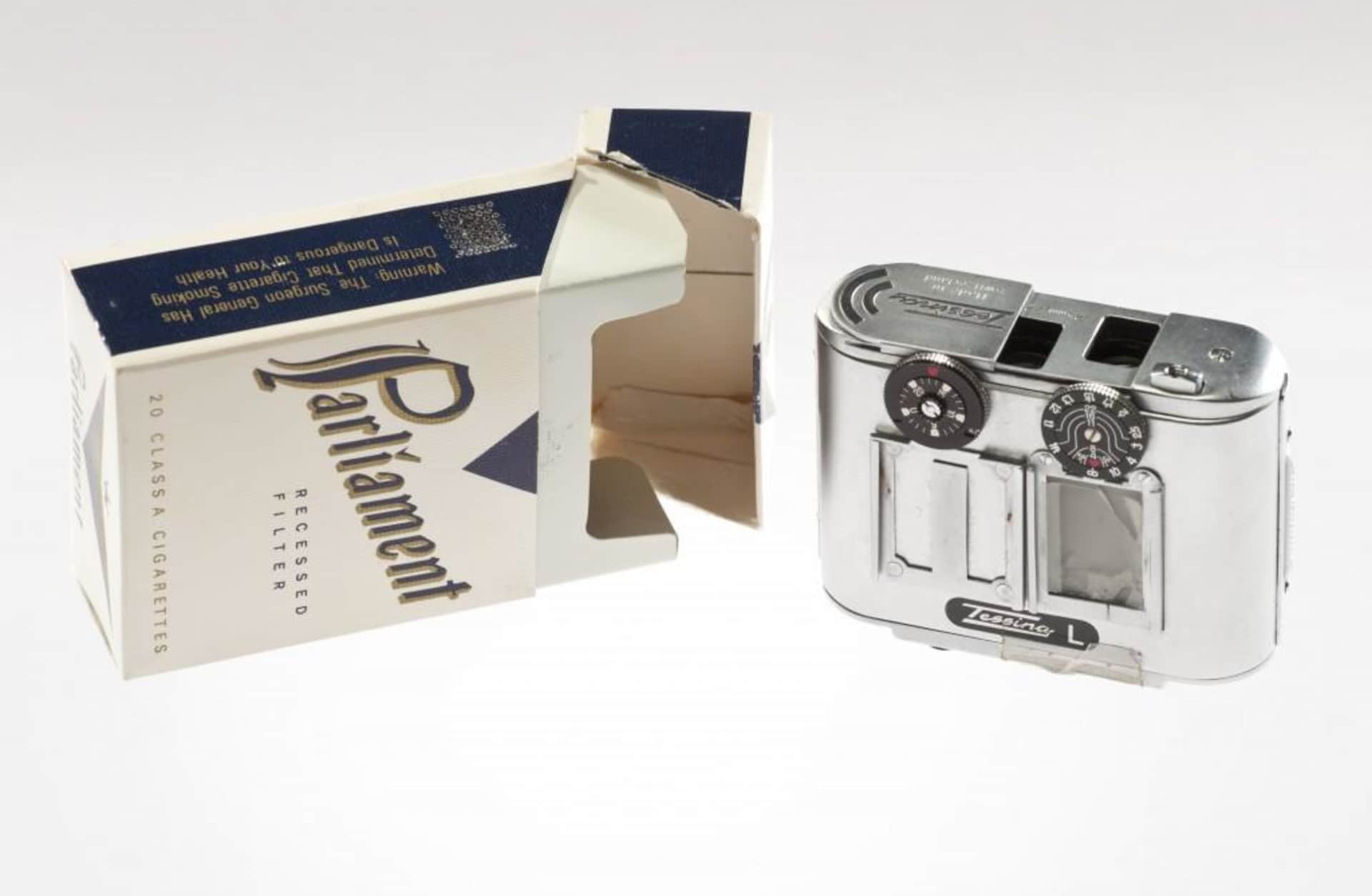 small silver-colored camera that fits in a cigarette pack