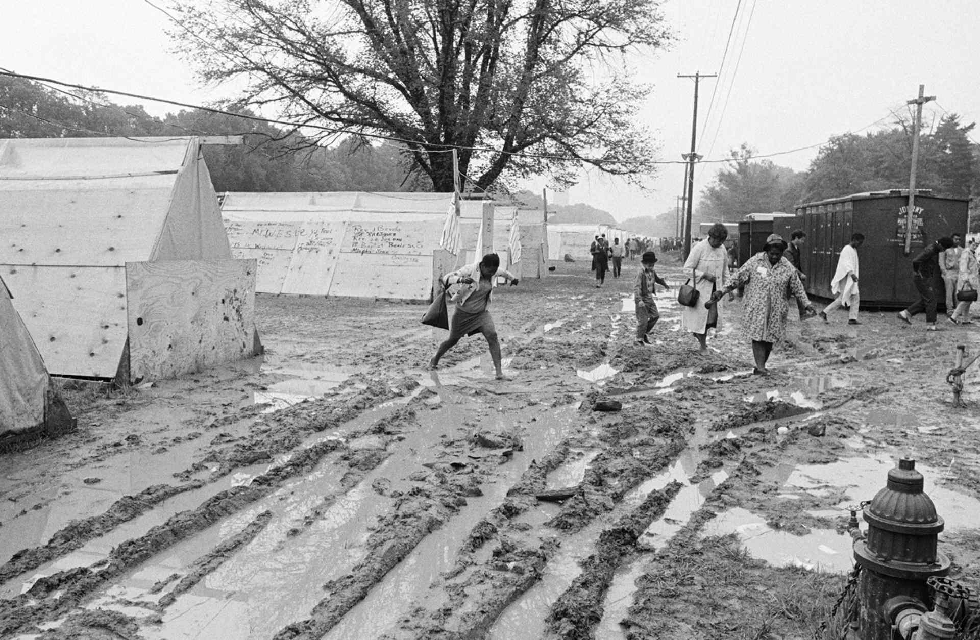 Hundreds of Poor People's Marchers abandoned Resurrection City 5/24 after an all-night rain turned their campsite into a quagmire of yellow mud.
