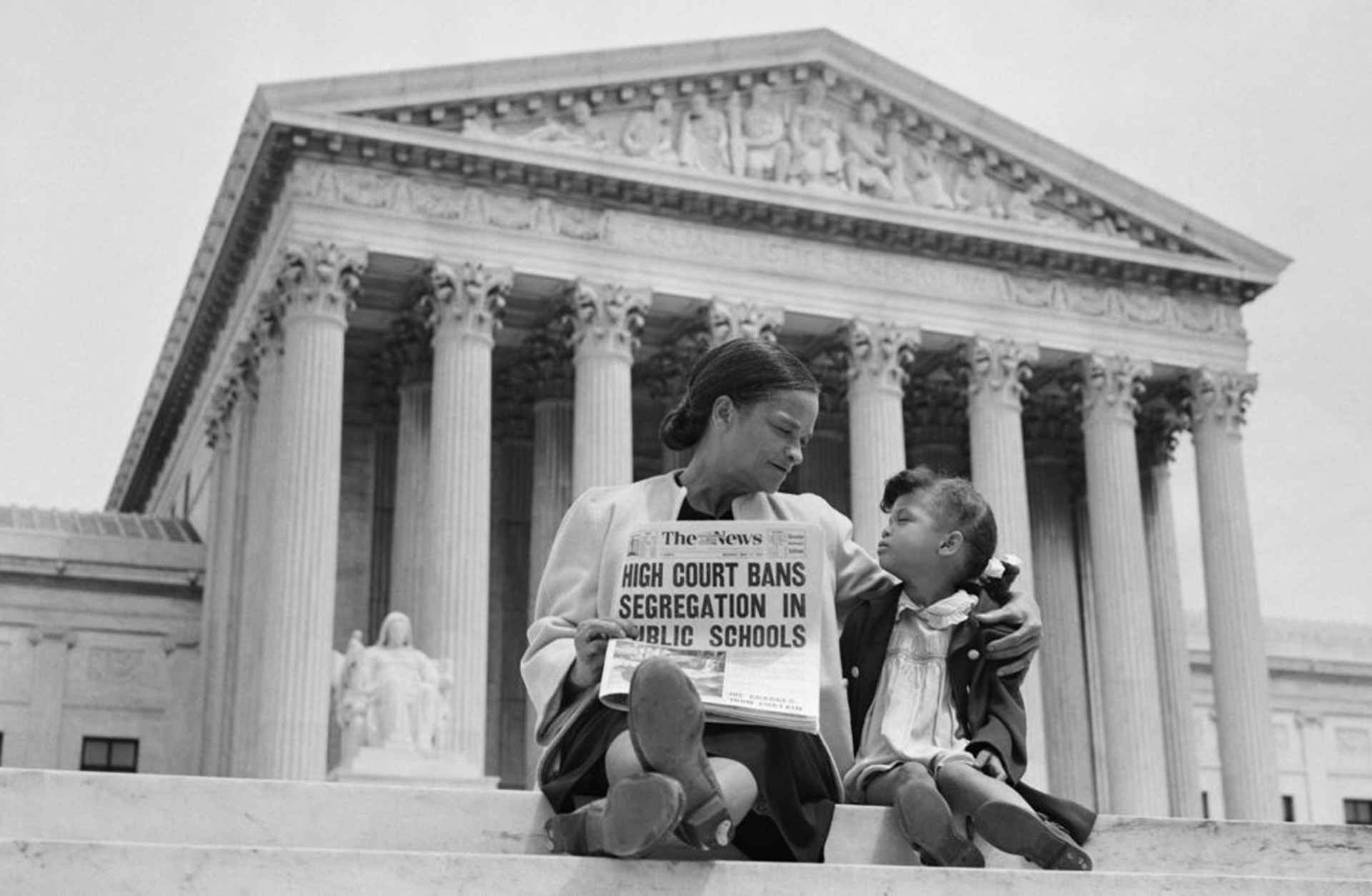 Nettie Hunt explaining to her daughter Nickie the meaning of the high court's ruling in the Brown v. Board of Education case on the steps of the U.S. Supreme Court. (Credit: Bettmann Archive/Getty Images)