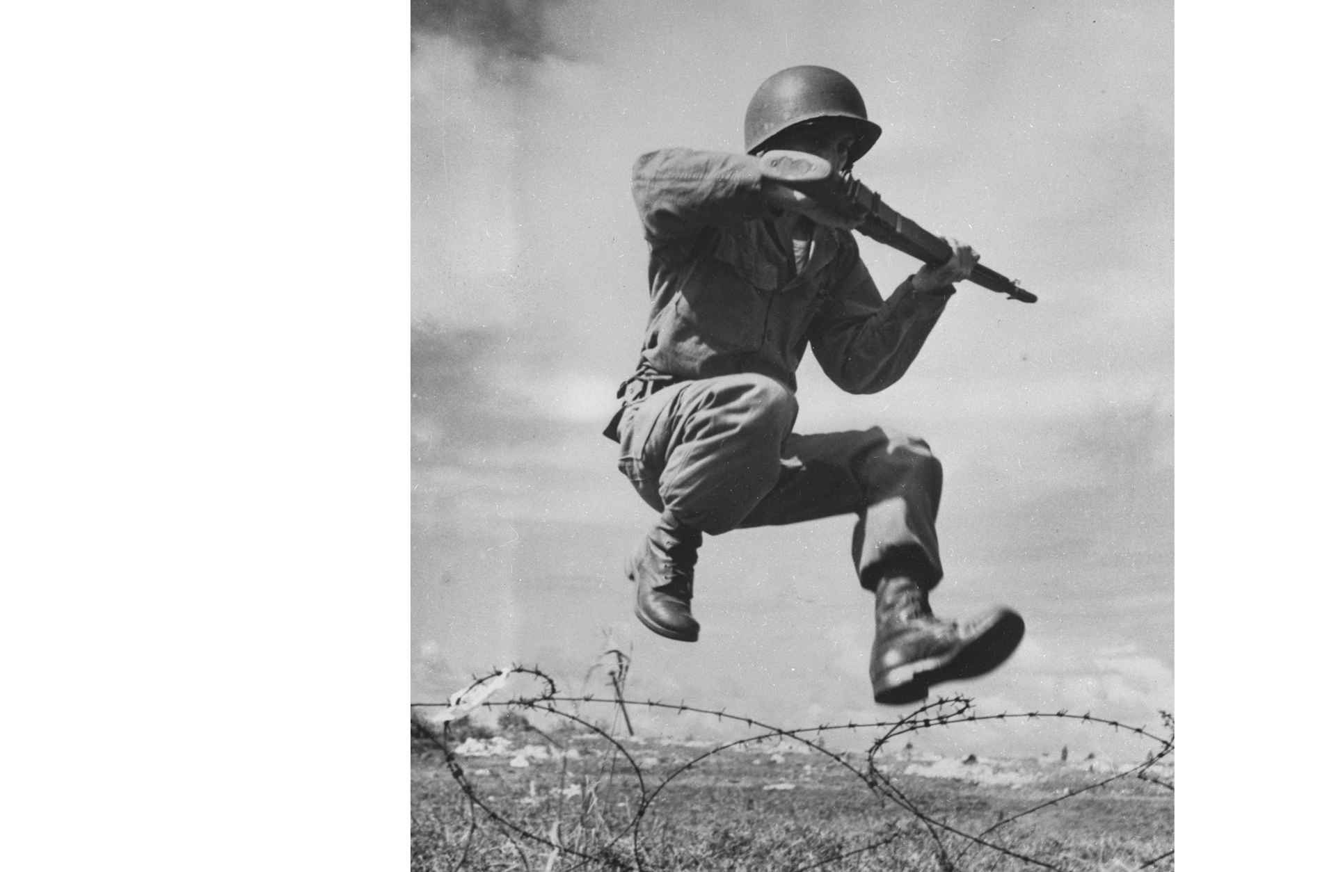 Training Of The "Fighting 65th" Of Puerto RicoPrivate Santiago Laboy, rifle ready, hurdles a mass of barbed wire during an important phase of combat training at Camp Tortuguero. (Photo by Bettmann Archive/Getty Images)