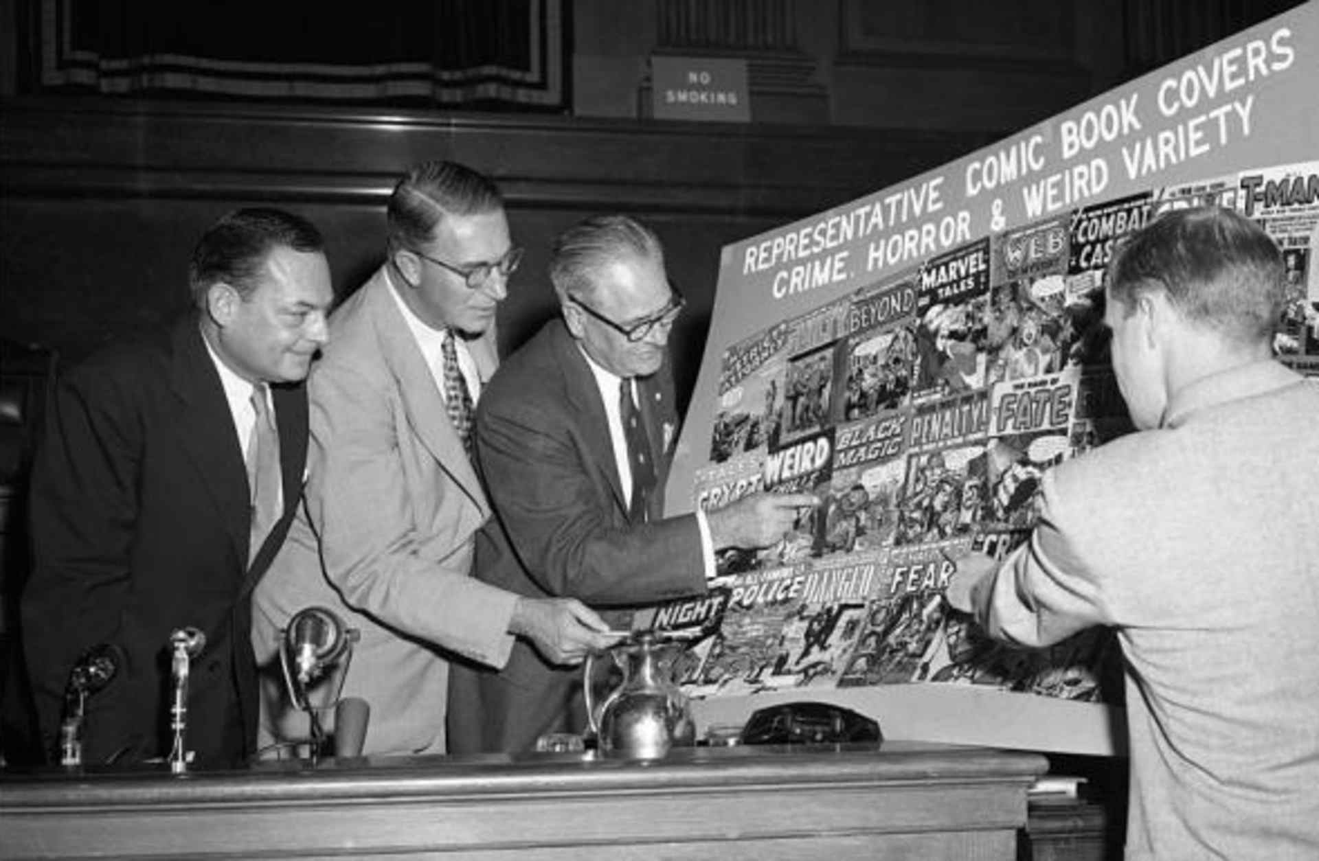 Senators Thomas D. Hennings, Estes Kefauver, Robert C. Hendrickson and Ricard Clendenen, look over sample covers of comic books at a New York hearing of a Senate sub-committee.