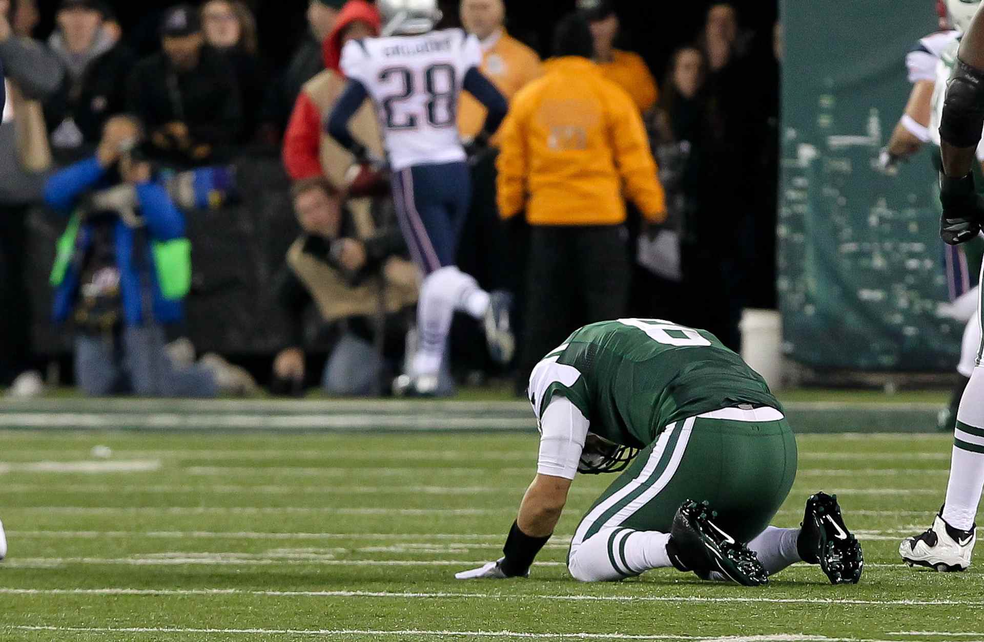 NFL: NOV 22 Patriots at Jets22 November 2012 New York Jets Mark Sanchez(6) stares at the turf as the Patriots Steve Gregory (28) scores a touchdown after his fumble during the game against the Patriots at Met Life Stadium. The Patriots won the game 49-19 (Photo by Rich Graessle/Icon SMI/Corbis/Icon Sportswire via Getty Images)