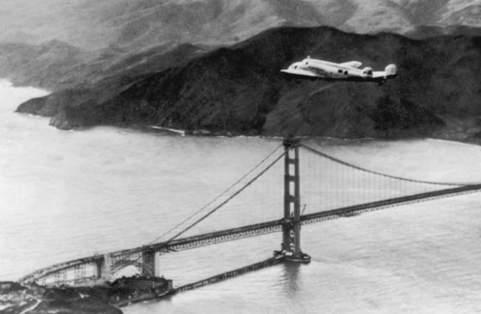The Lockheed Electra 'Flying Laboratory', piloted by American aviator Amelia Earhart and Fred Noonan, over the Golden Gate bridge in California, at the start of a planned round-the-world flight. (Credit: Keystone/Hulton Archive/Getty Images)