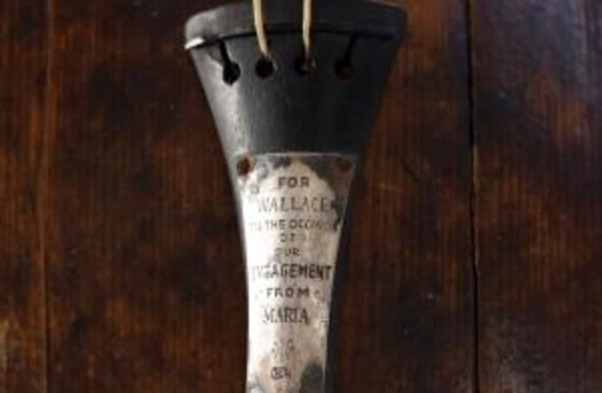 The violin owned and played by bandmaster Wallace Hartley during the final moments before the sinking of the Titanic, displayed at a conservation studio in Lurgan, Northern Ireland, 2013. The violin was recovered along with his body 10 days after he and other band members played to calm passengers on the deck of the stricken ship after it hit an iceberg on its maiden voyage. The instrument bears an engraved message from the musician's fiance that reads: For Wallace, on the occasion of our engagement. From Maria.