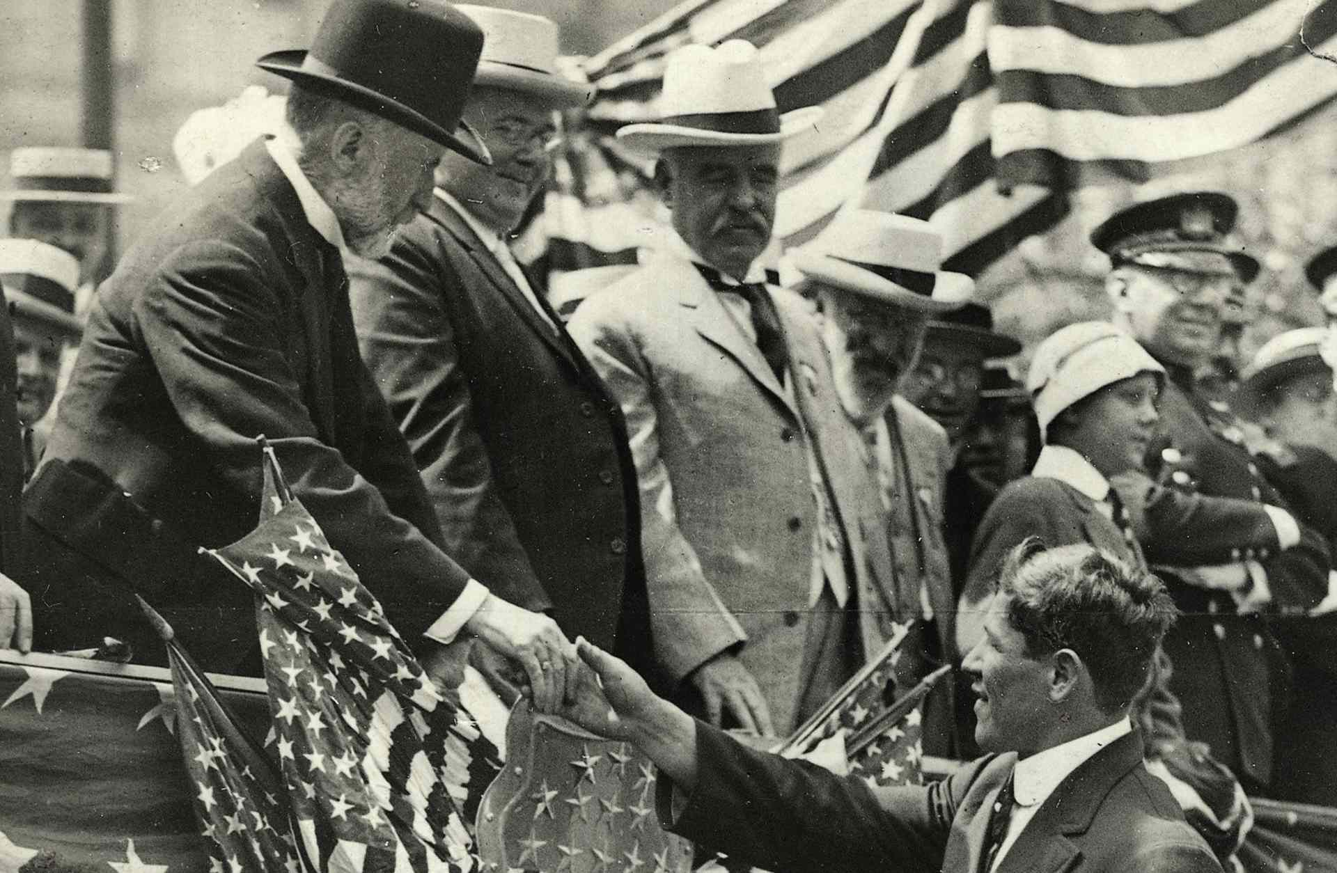 New York City Mayor William Jay Gaynor shakes the hand of athlete Jim Thorpe during the parade of the American Olympic victors. T