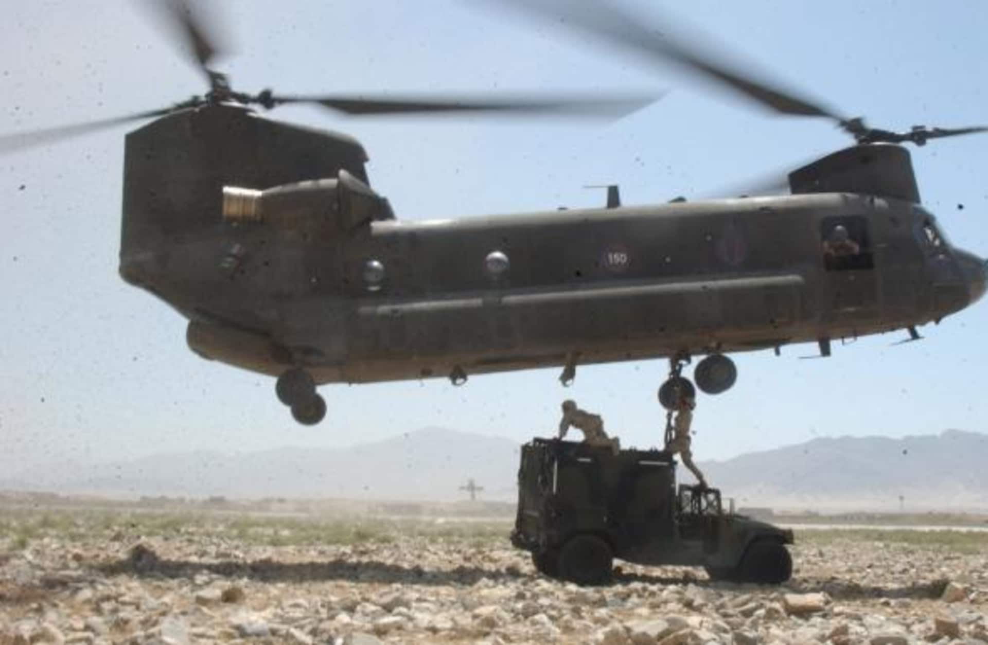 U.S. Army soldiers prepare a Humvee to be sling-loaded by a CH-47 Chinook helicopter in Bagram, Afghanistan, on July 24, 2004. (Credit: Public Domain)