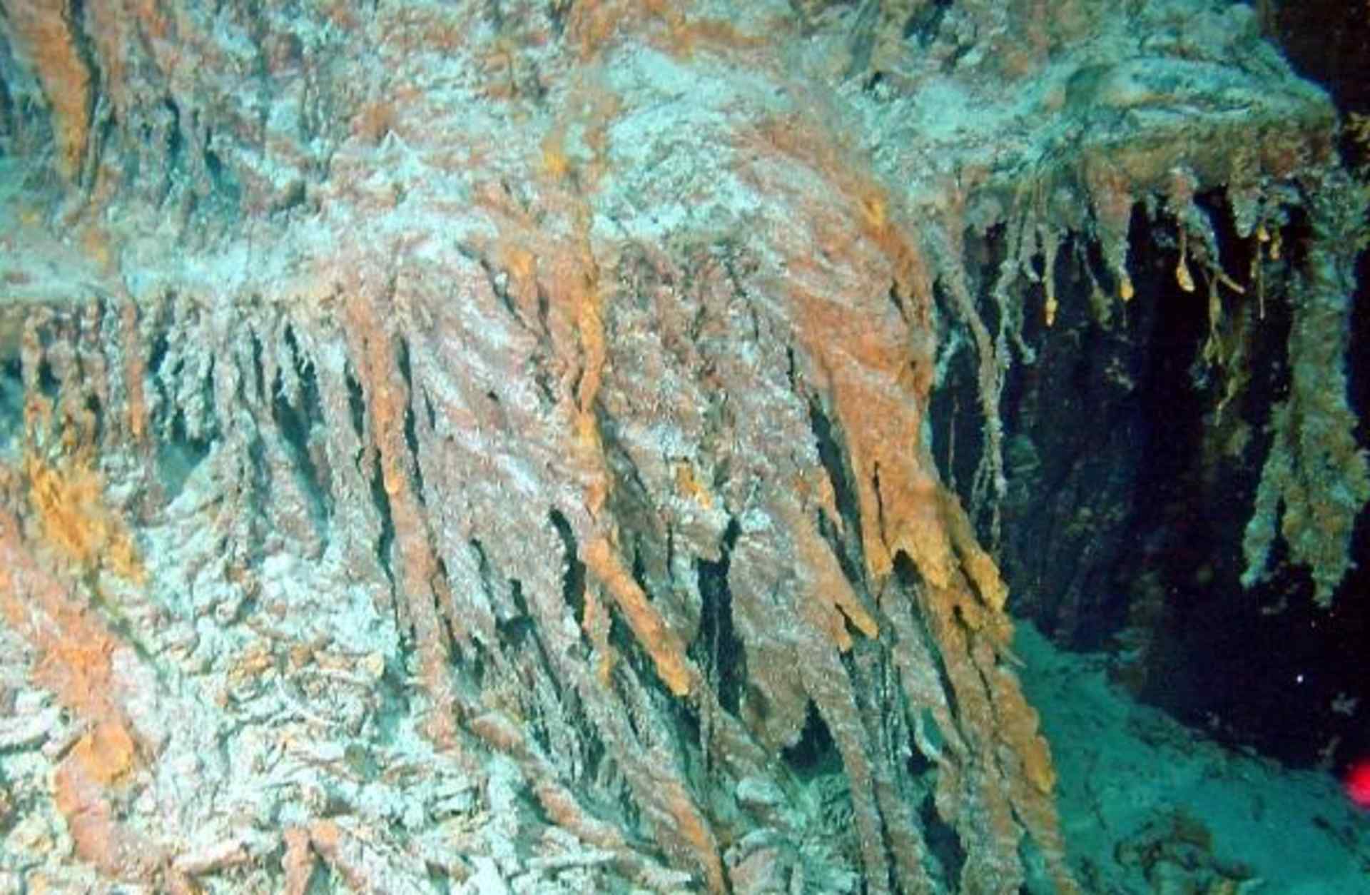 Window frames belonging to the Titanic. Rusticles are growing on either side of the window frames. (Credit: Public Domain)