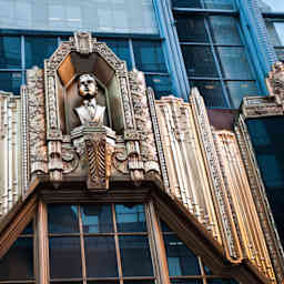 Metal bass relief with statue of Alan E. Lefcourt above entrance to Brill Building, Times Square, Manhattan, New York City, USA