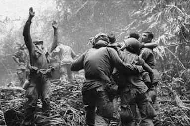 This April 1968 file photo shows the first sergeant of A Company, 101st Airborne Division, guiding a medevac helicopter through the jungle foliage to pick up casualties suffered during a five-day patrol near Hue.