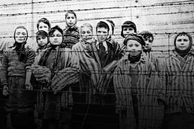 A group of child survivors behind a barbed wire fence at the Nazi concentration camp at Auschwitz-Birkenau in southern Poland, on the day of the camp’s liberation by the Red Army, 27th January 1945.