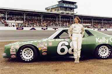 Janet Guthrie #68 stands in front of her car before the 1977 Winston Cup Daytona 500 on February 20, 1977.