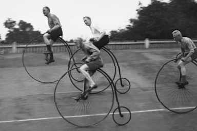 Pedal Your Way Through the Bicycle’s Bumpy History; A group of cycling enthusiasts on their Victorian-style penny farthings, training for a race. (Credit: Douglas Miller/Topical Press Agency/Getty Images)