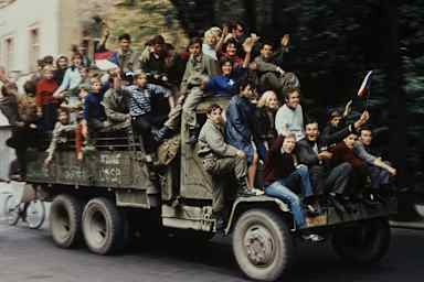 Protesters and residents of Prague, Czechoslovakia ride on a military vehicle on a city street in the capital during the Soviet and Warsaw Pact invasion of the country in August 1968.