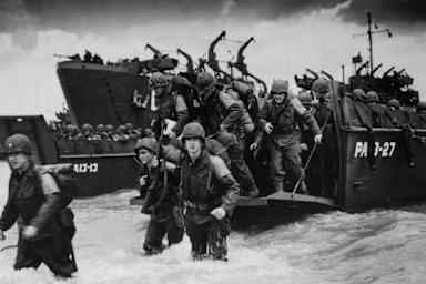 Reinforcements disembarking from a landing barge at Normandy during the Allied Invasion of France on D-Day.