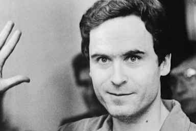 Serial Murderer Theodore "Ted" Bundy walks forward and waves to TV camera as his indictment for the January murders of Lisa Levy and Margaret Bowman is read at the Leon County Jail.